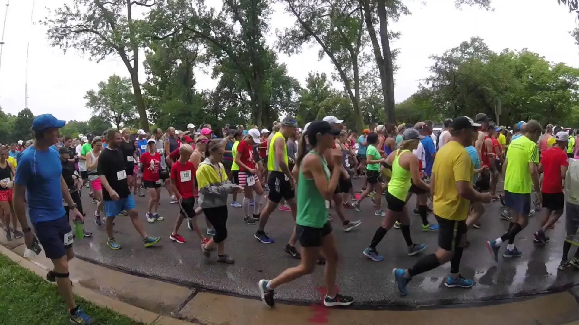 The image shows a group of people participating in a running event, likely a marathon