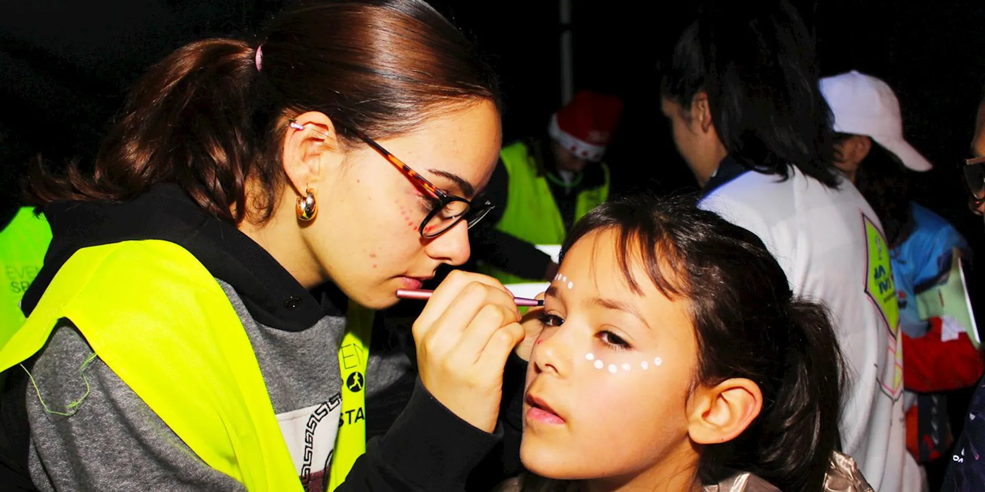The image shows a person with a high-visibility vest and glasses, who appears