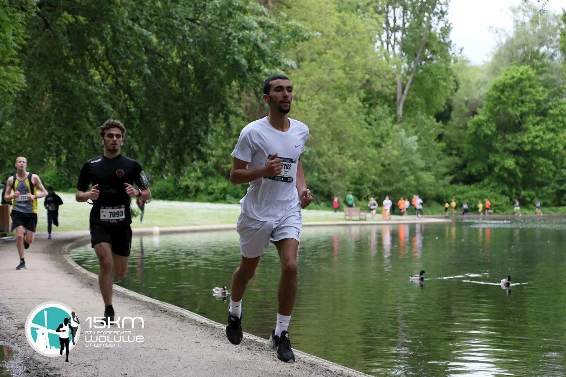 The image shows a group of runners participating in a race. The focus is on