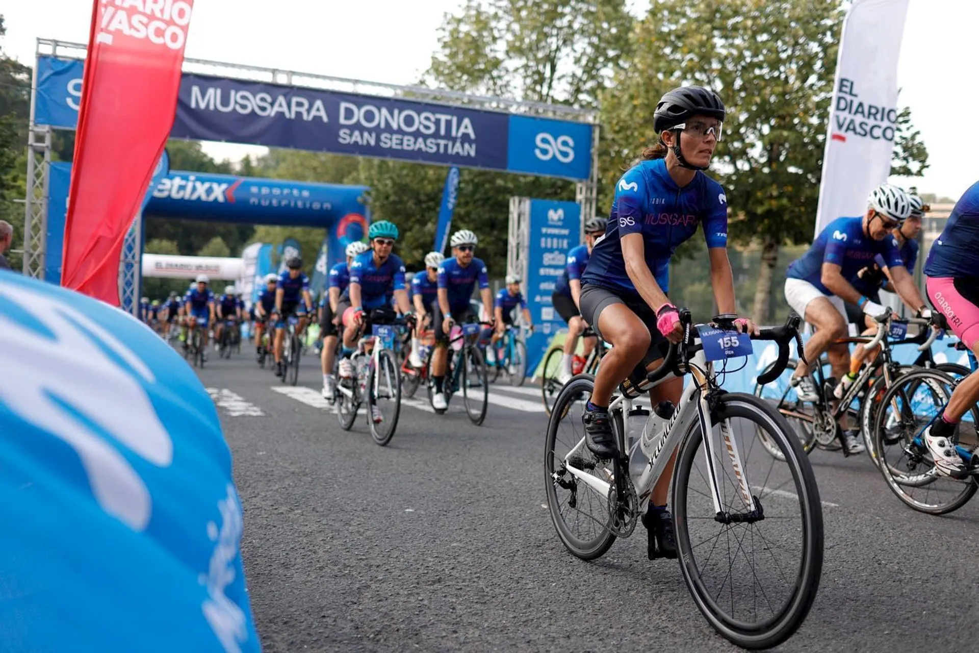 The image shows a group of cyclists during a competitive event or possibly a cycling marathon