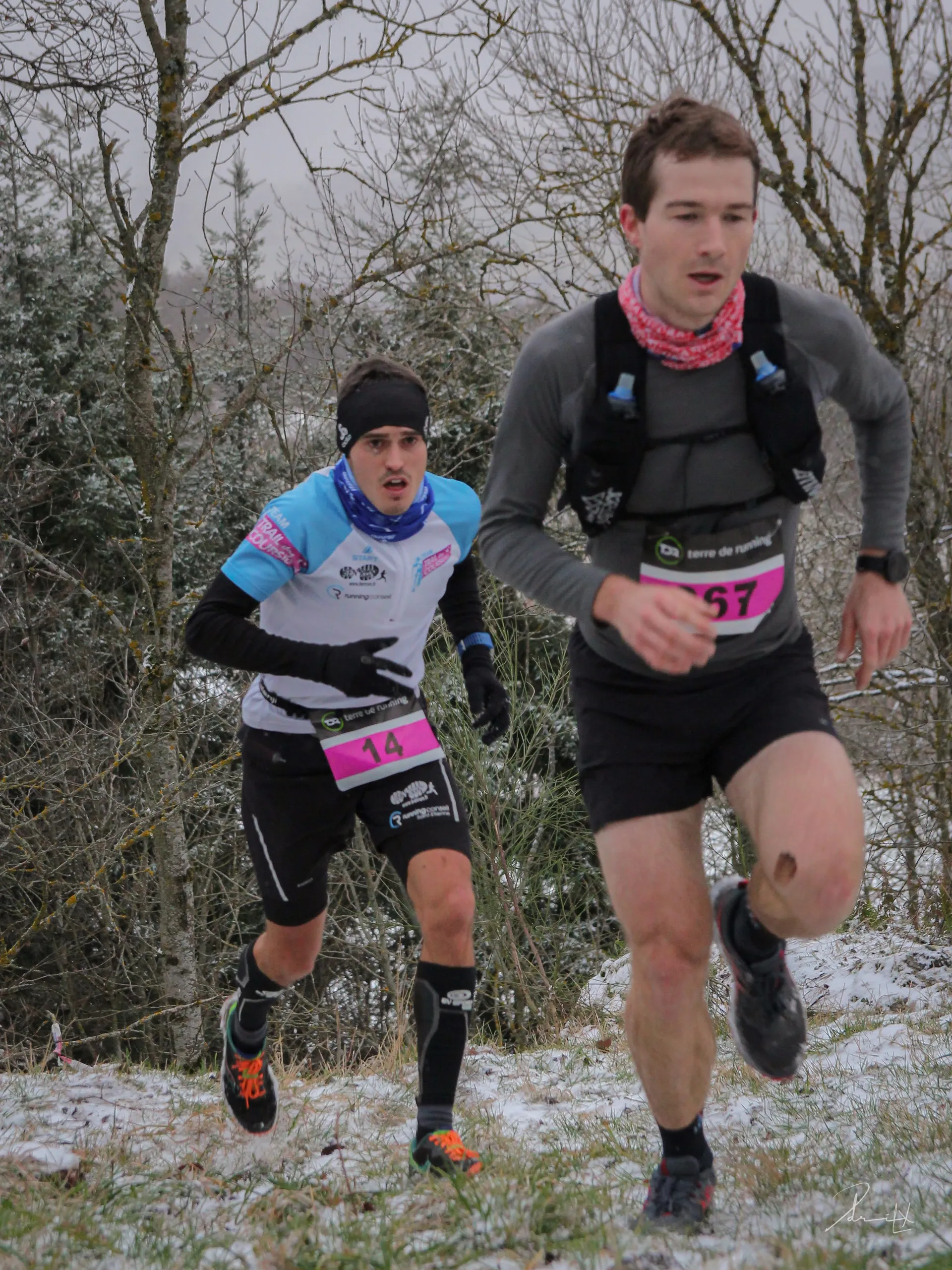 The image shows two individuals engaged in a running event, likely a race or a