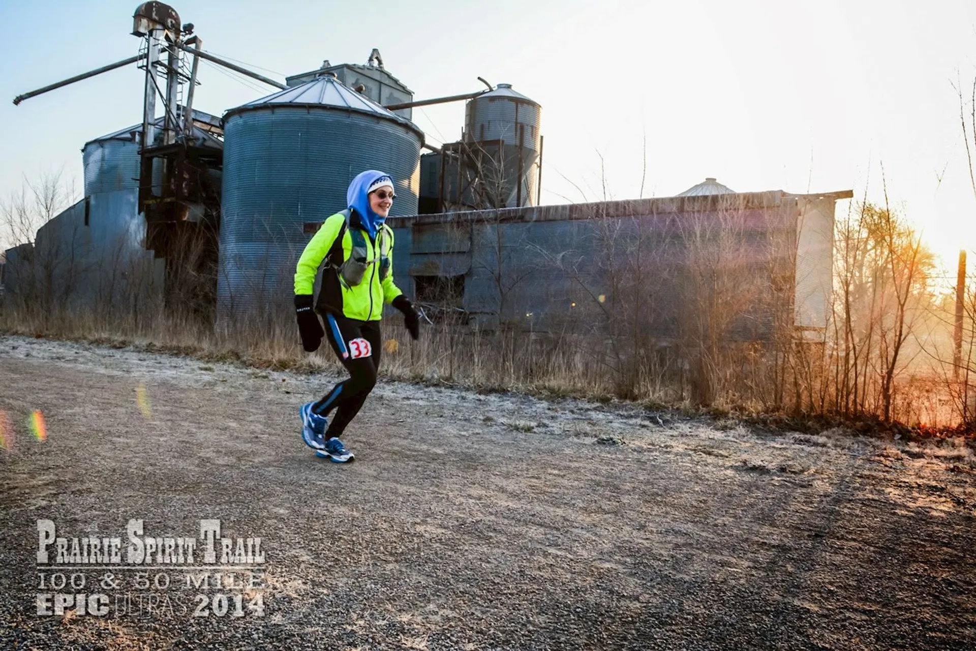 The image shows a person running on a dirt road during what appears to be either