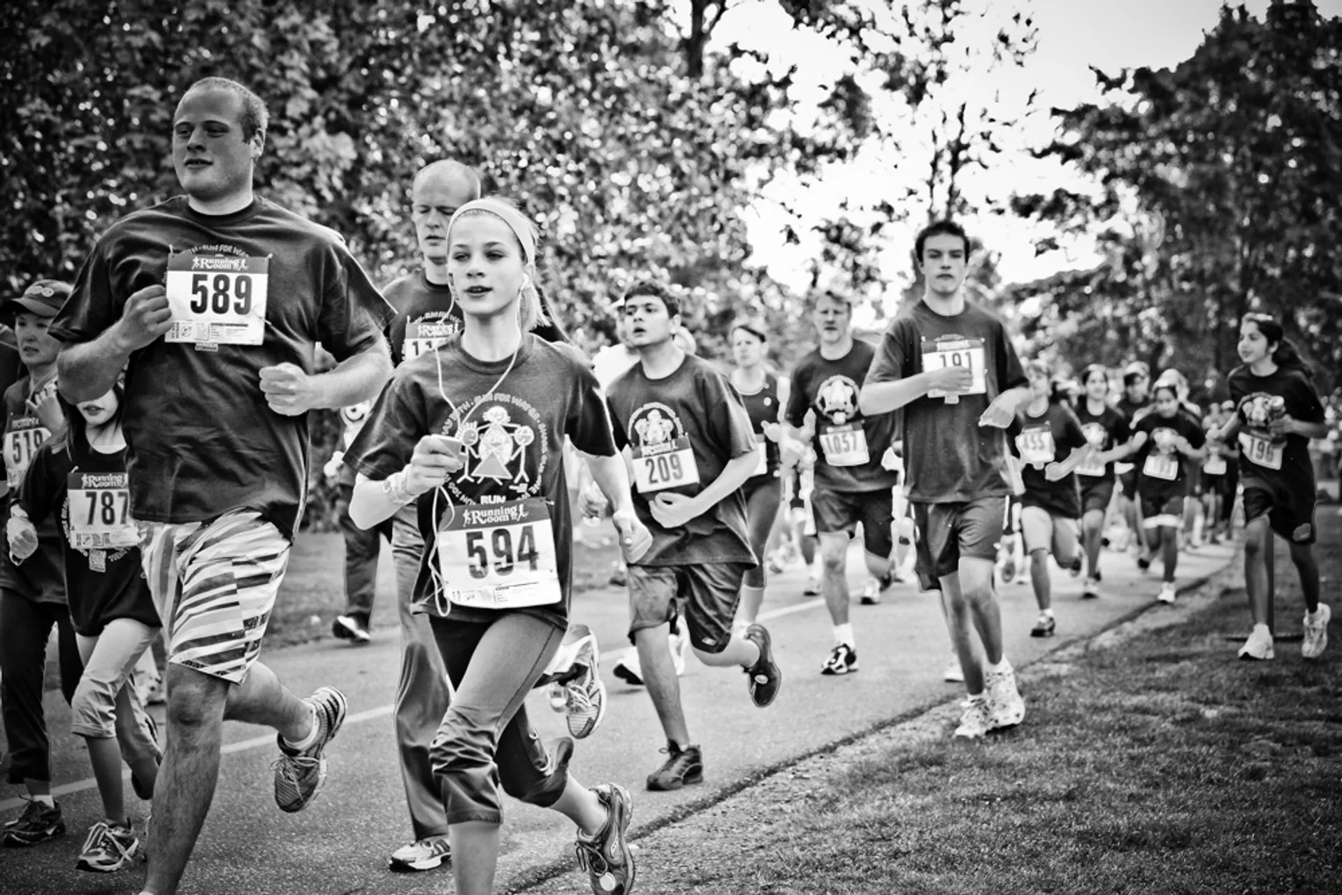 The image is a black and white photograph of a group of people participating in a
