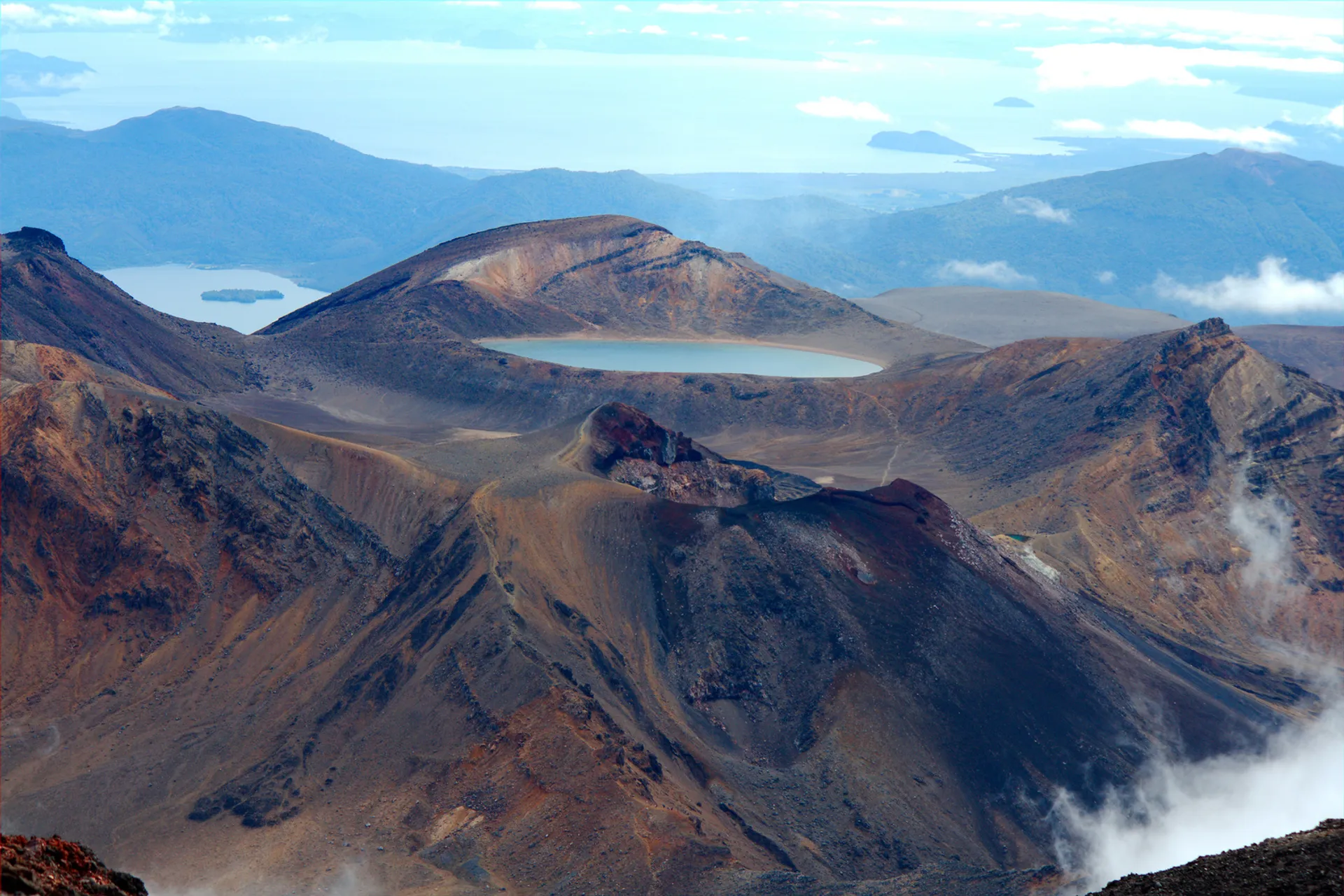 The image showcases a dramatic landscape that appears to be a volcanic terrain. There are