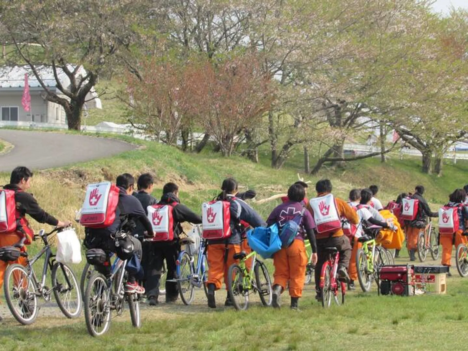 The image shows a group of people, who appear to be students due to the