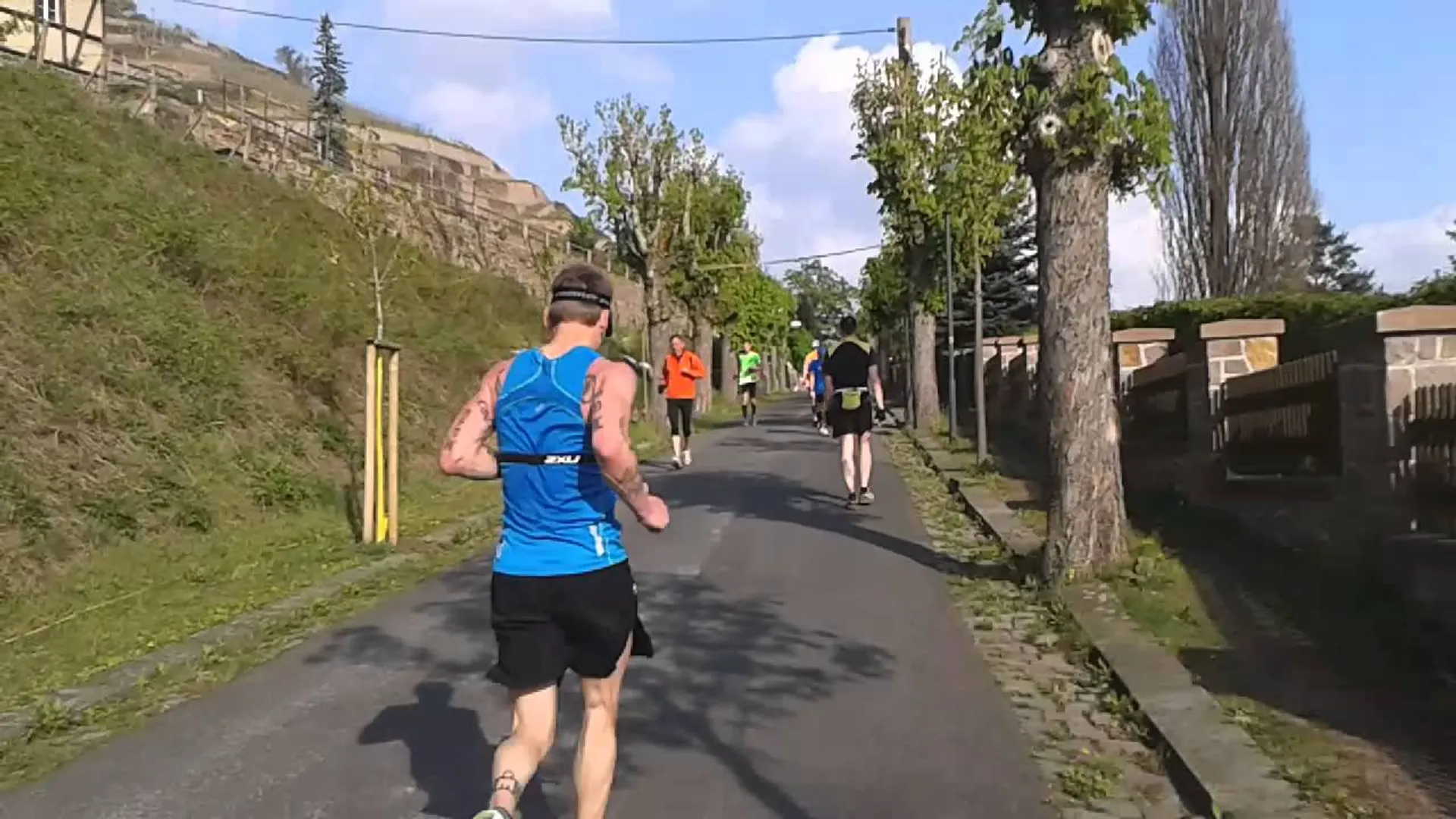 The image shows a group of individuals participating in a running activity, likely a fun