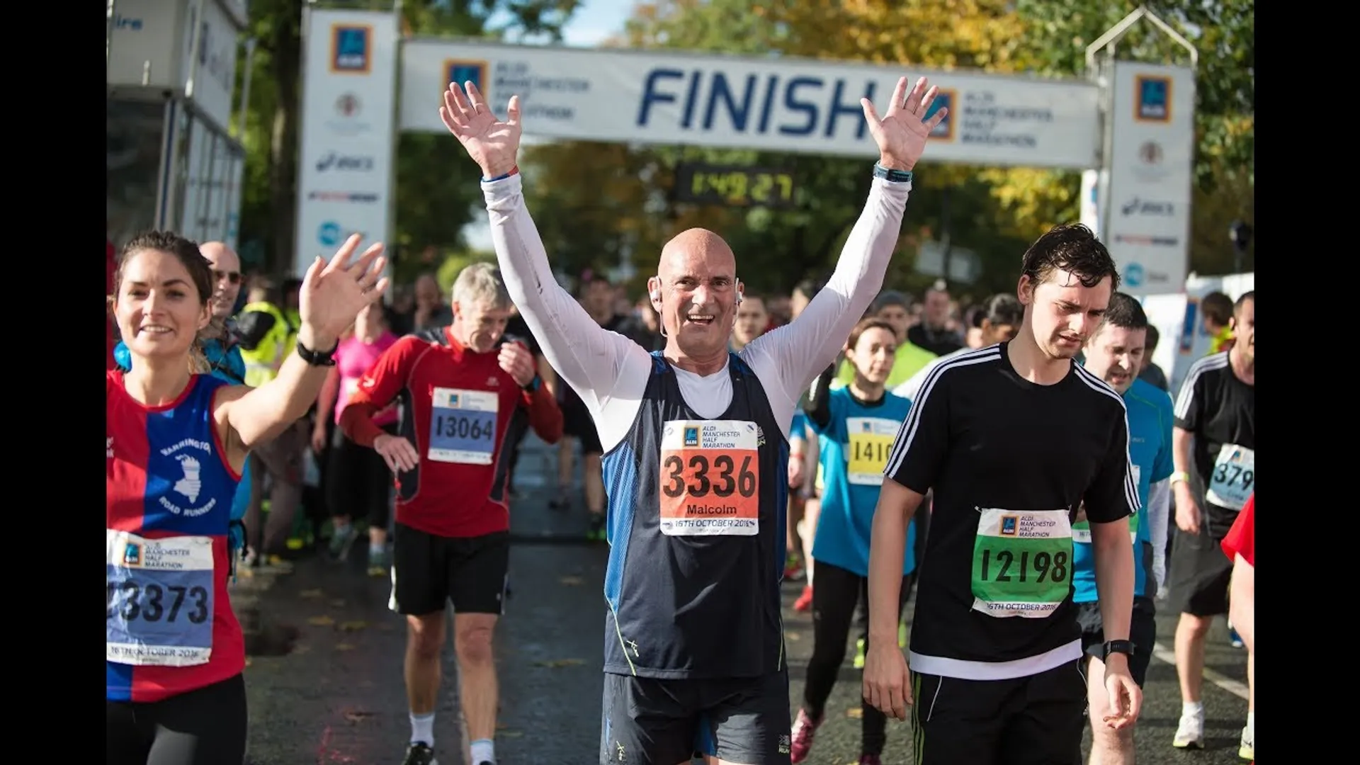 This image shows a group of runners crossing the finish line at a running event.