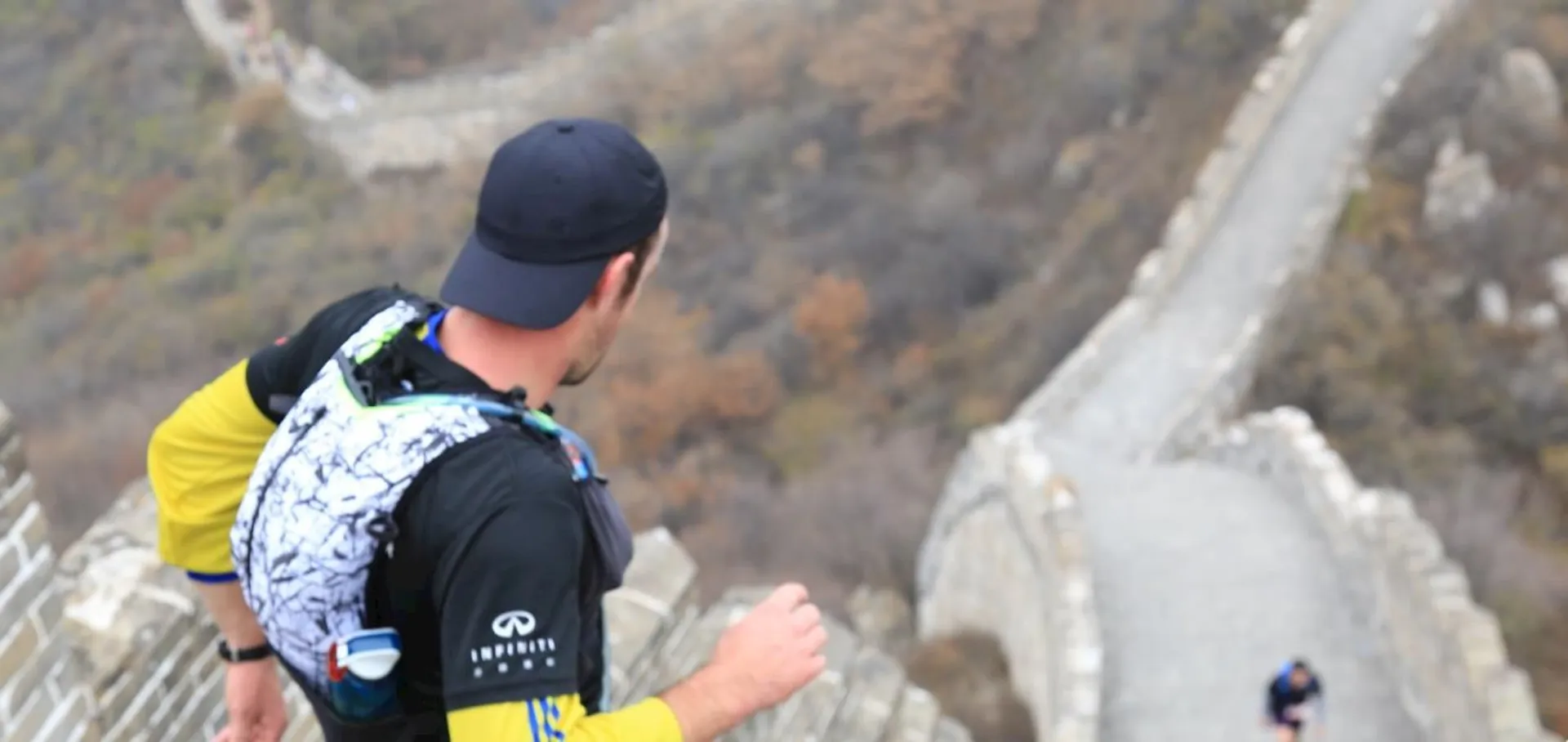 The image features a person from behind as they seem to be running or walking along