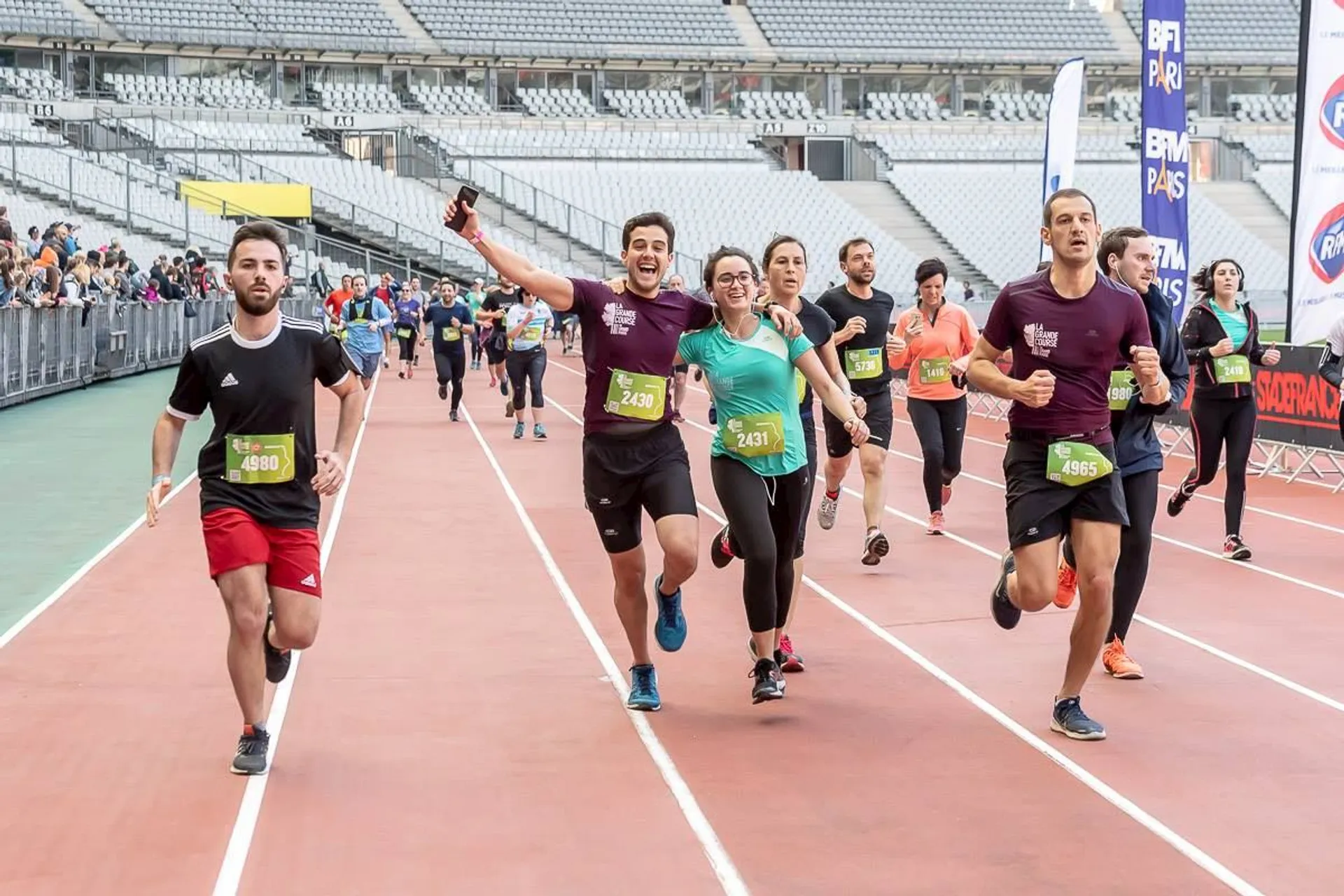 In the image, we see a group of people running on a track, likely
