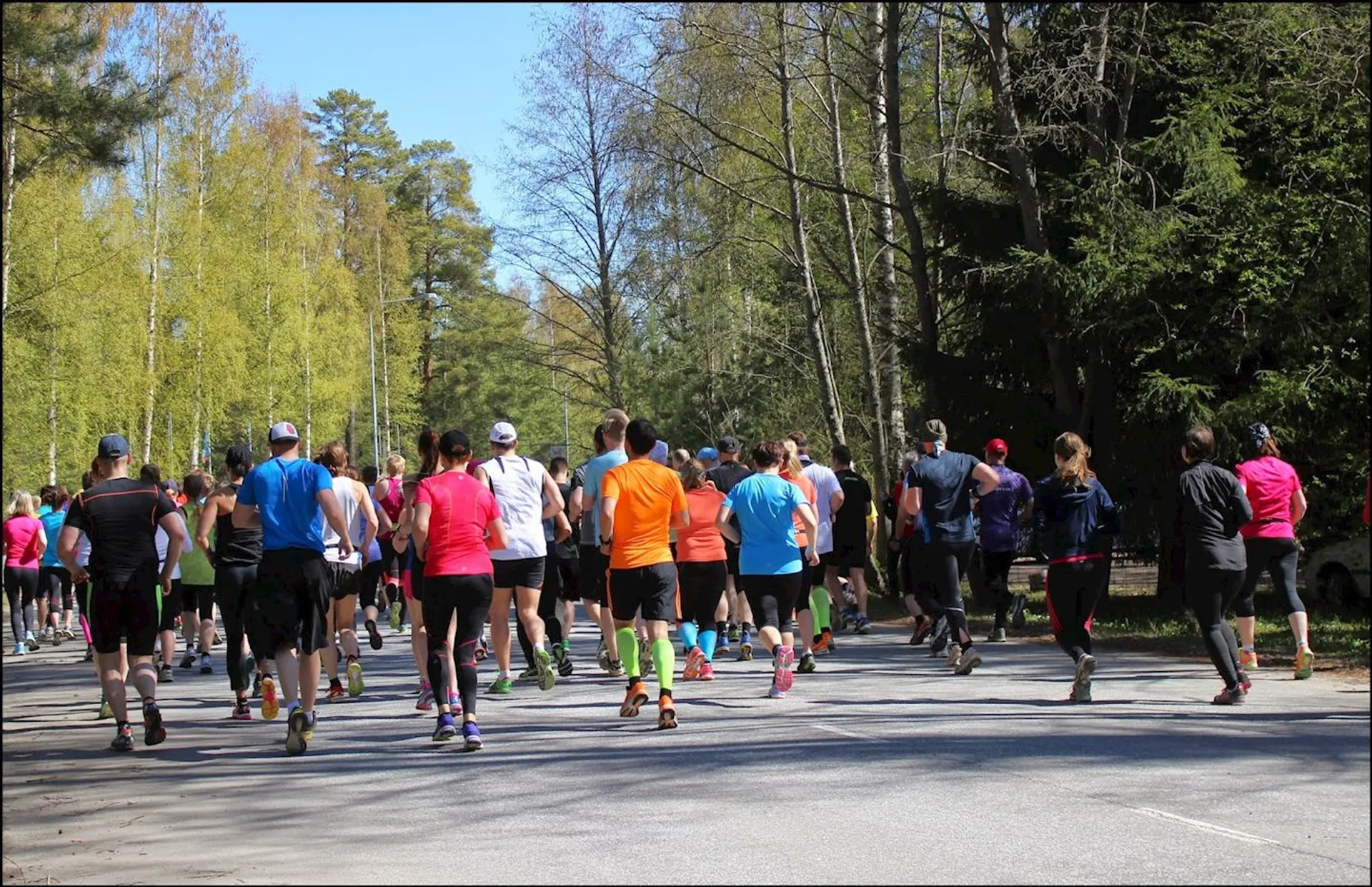 The image shows a group of people participating in a running event, likely a race