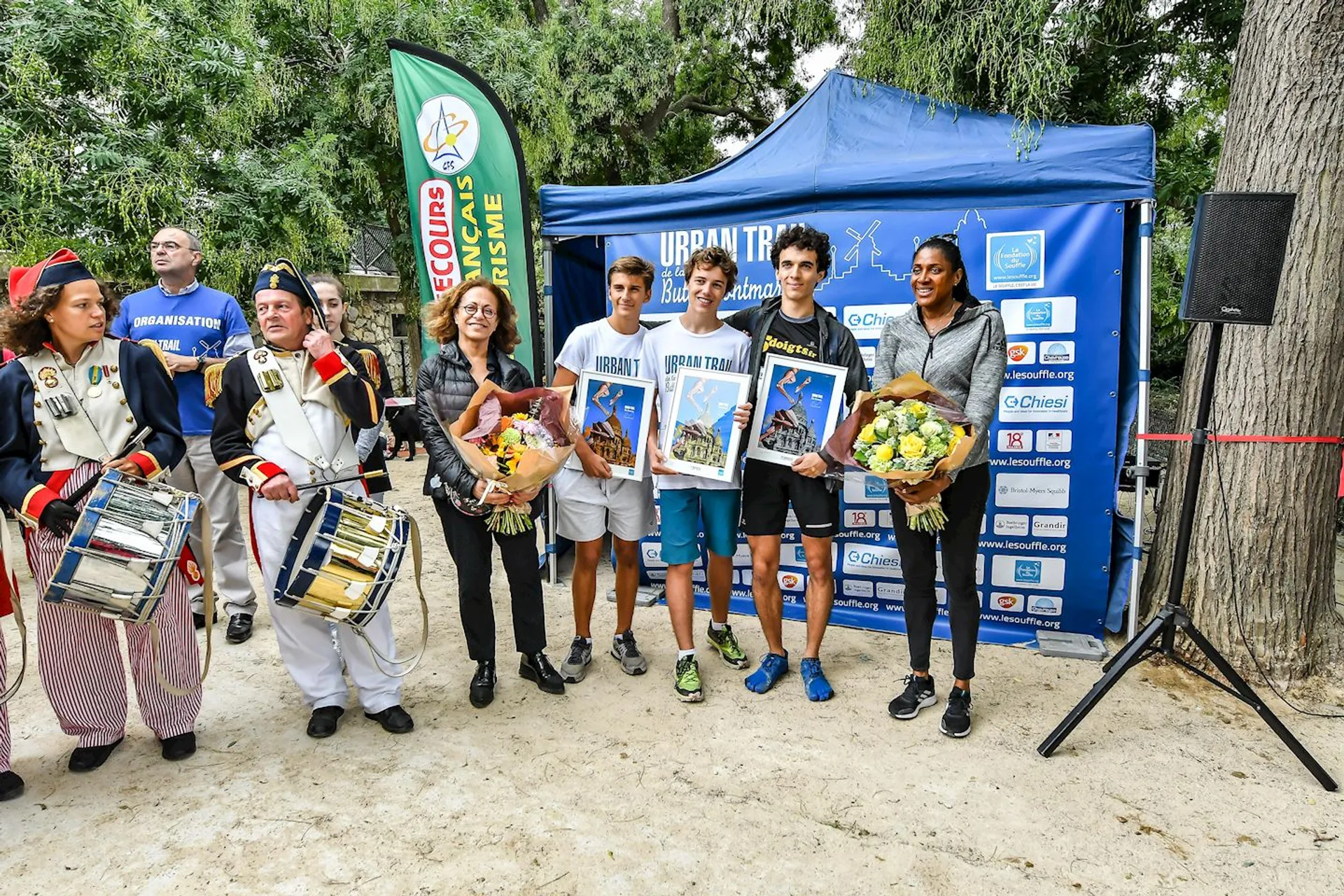 The image shows a group of people at what appears to be a public event,