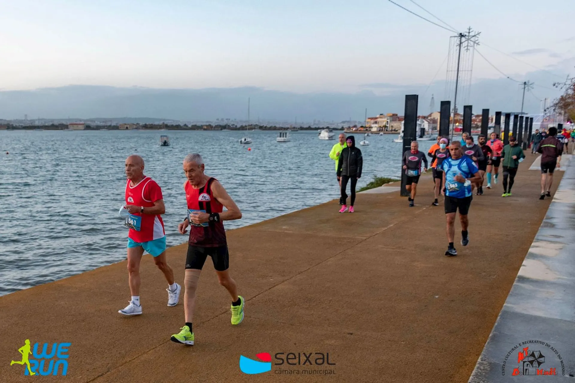 The image shows a group of people participating in a running event. They appear to