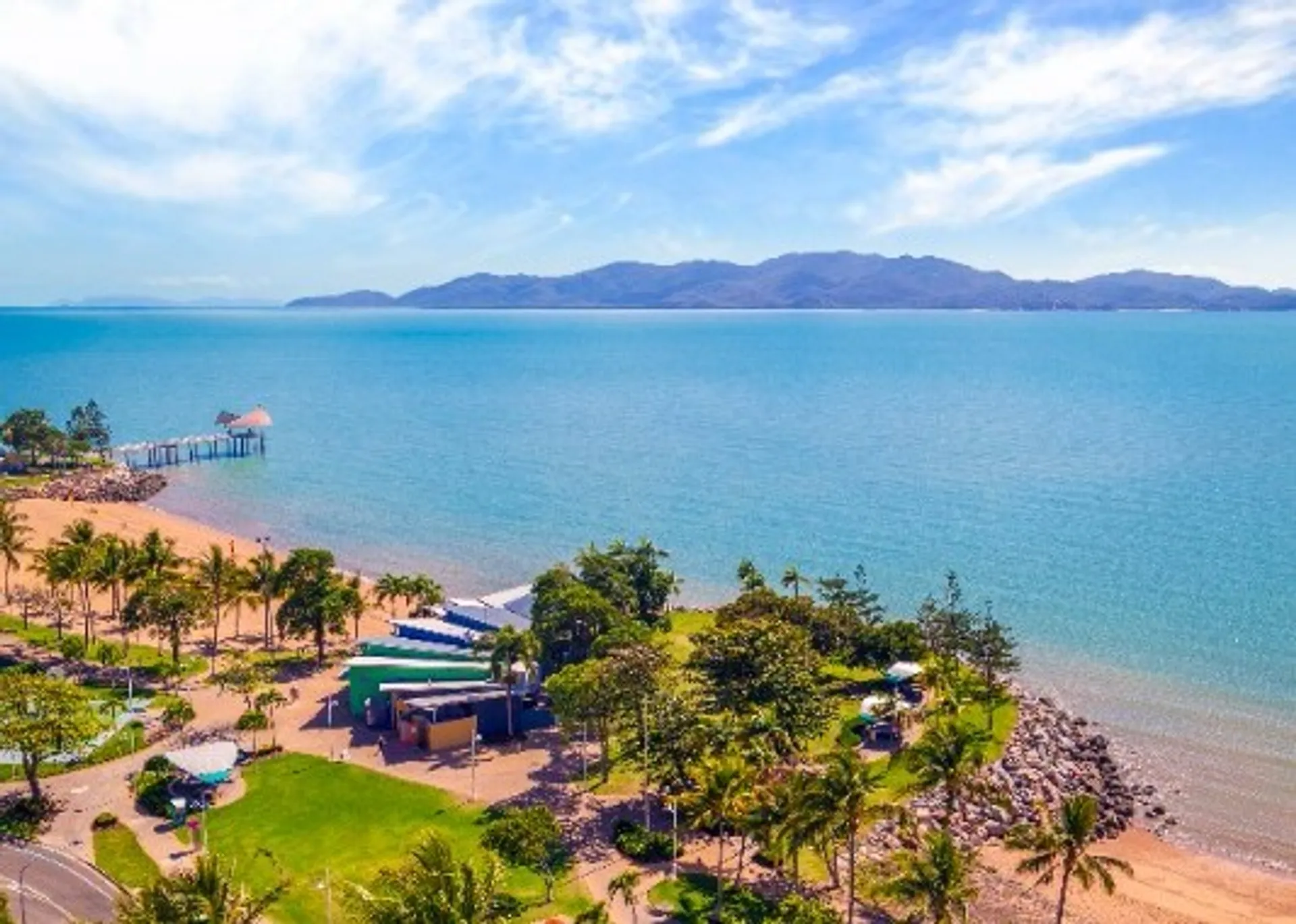 The image depicts a beautiful coastal scene. It features an expansive body of water that