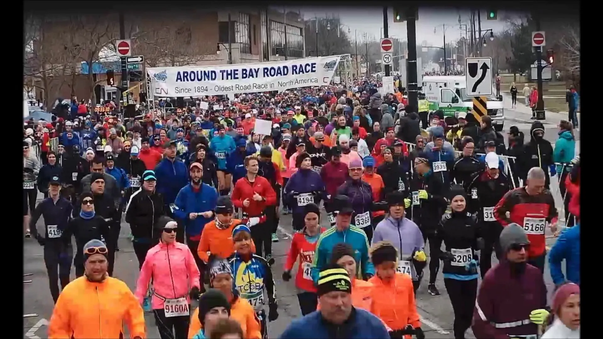 This image shows a large group of runners participating in a road race titled "AR