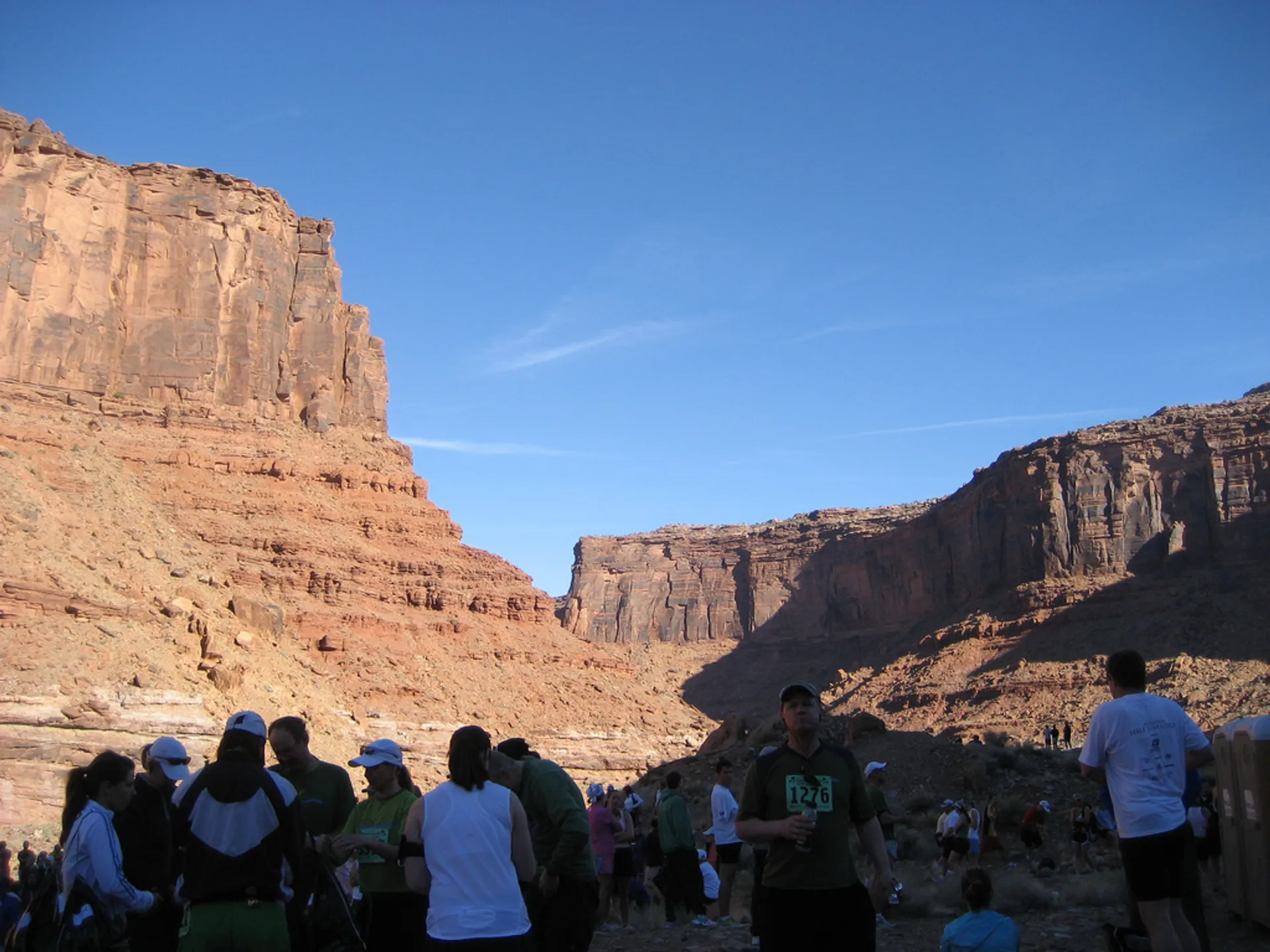 This image shows a group of people, likely participants in a running event, considering