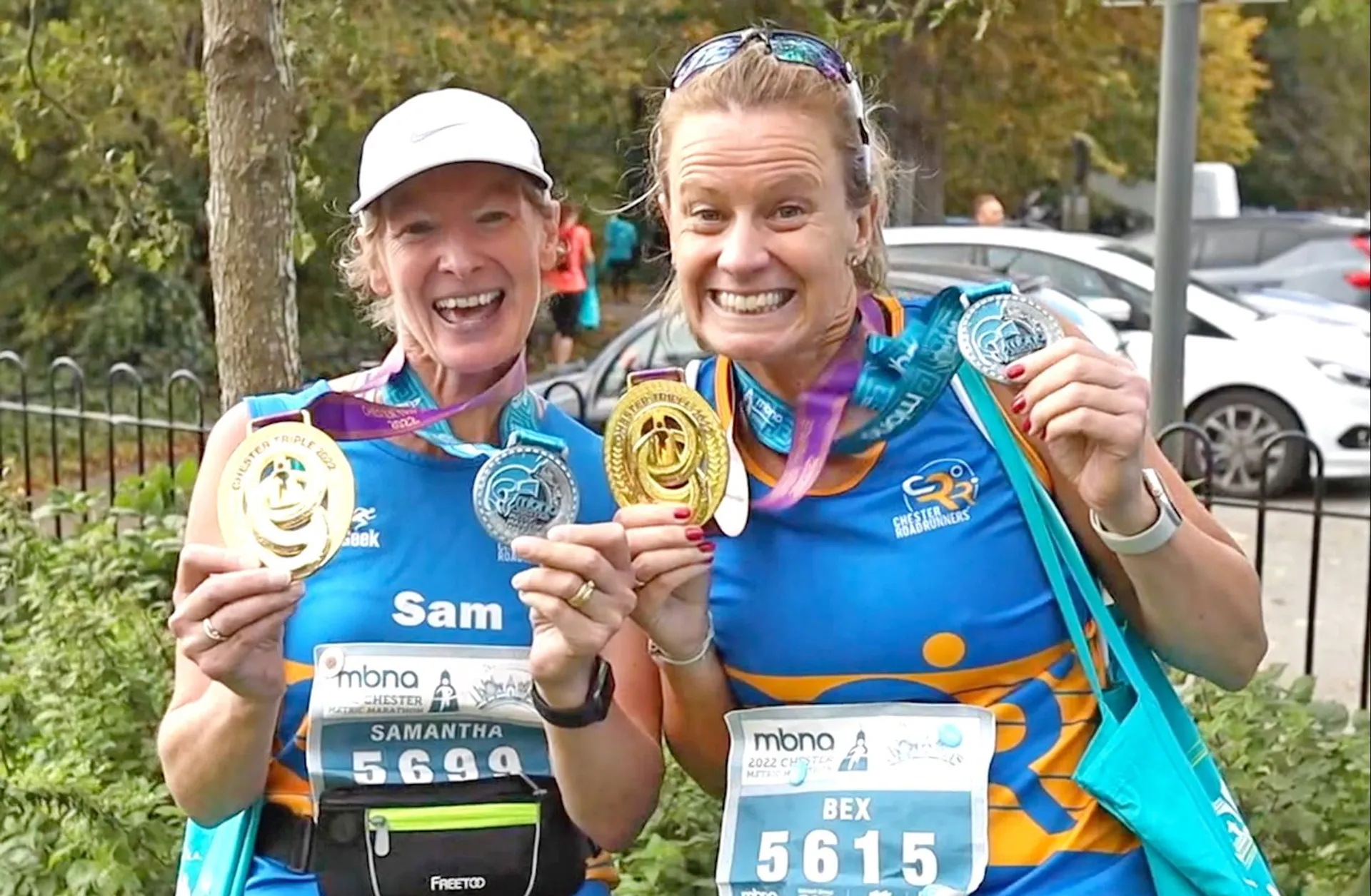 The image shows two individuals who have participated in a running event, as indicated by