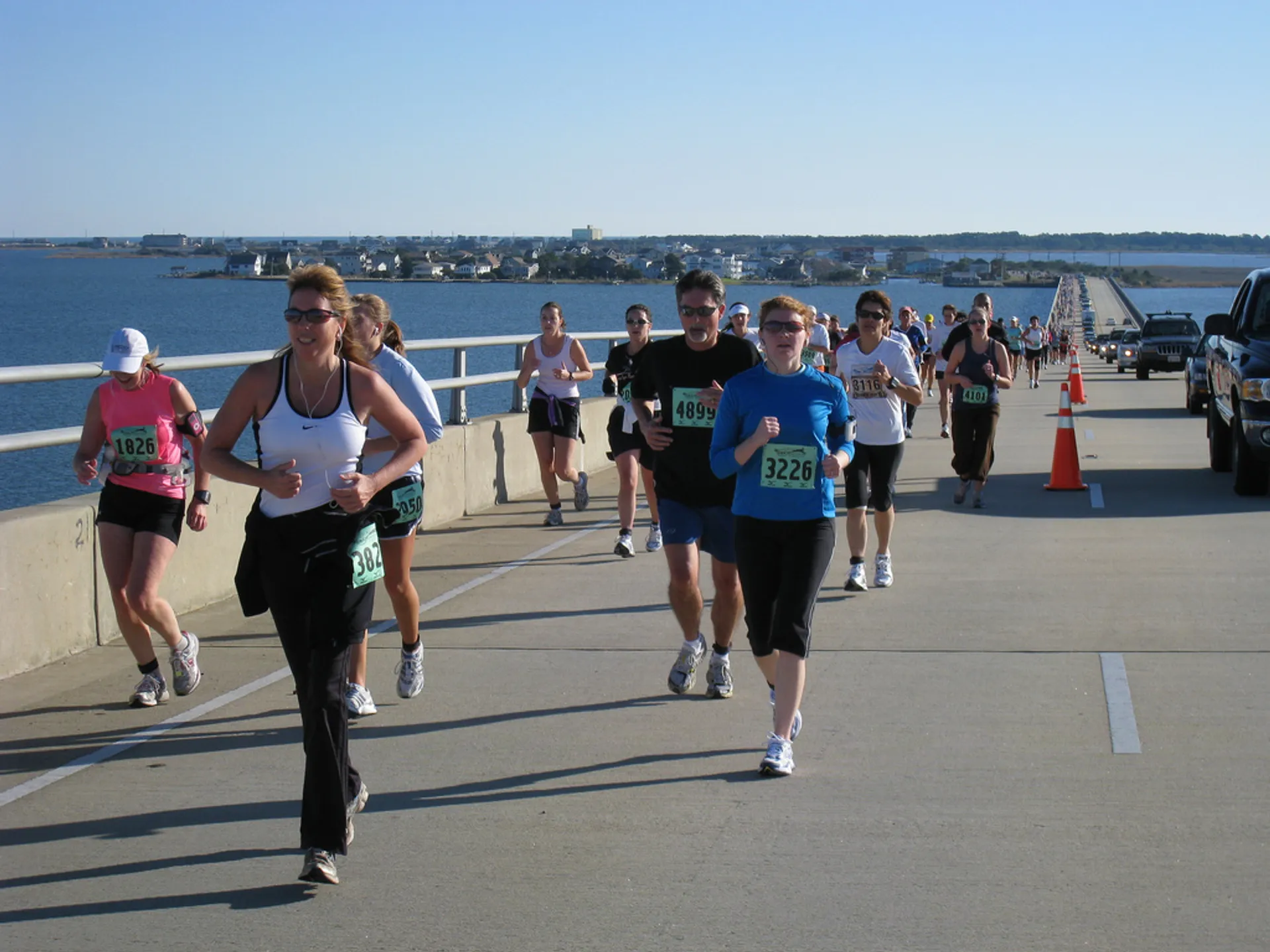 The image depicts a group of people participating in a running event, often referred to