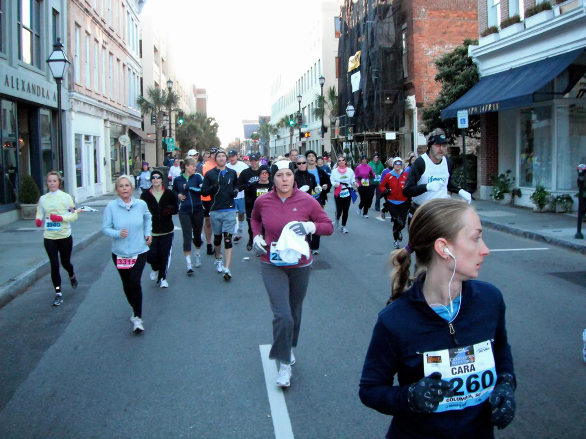 The image shows a group of people participating in a road race. They appear to