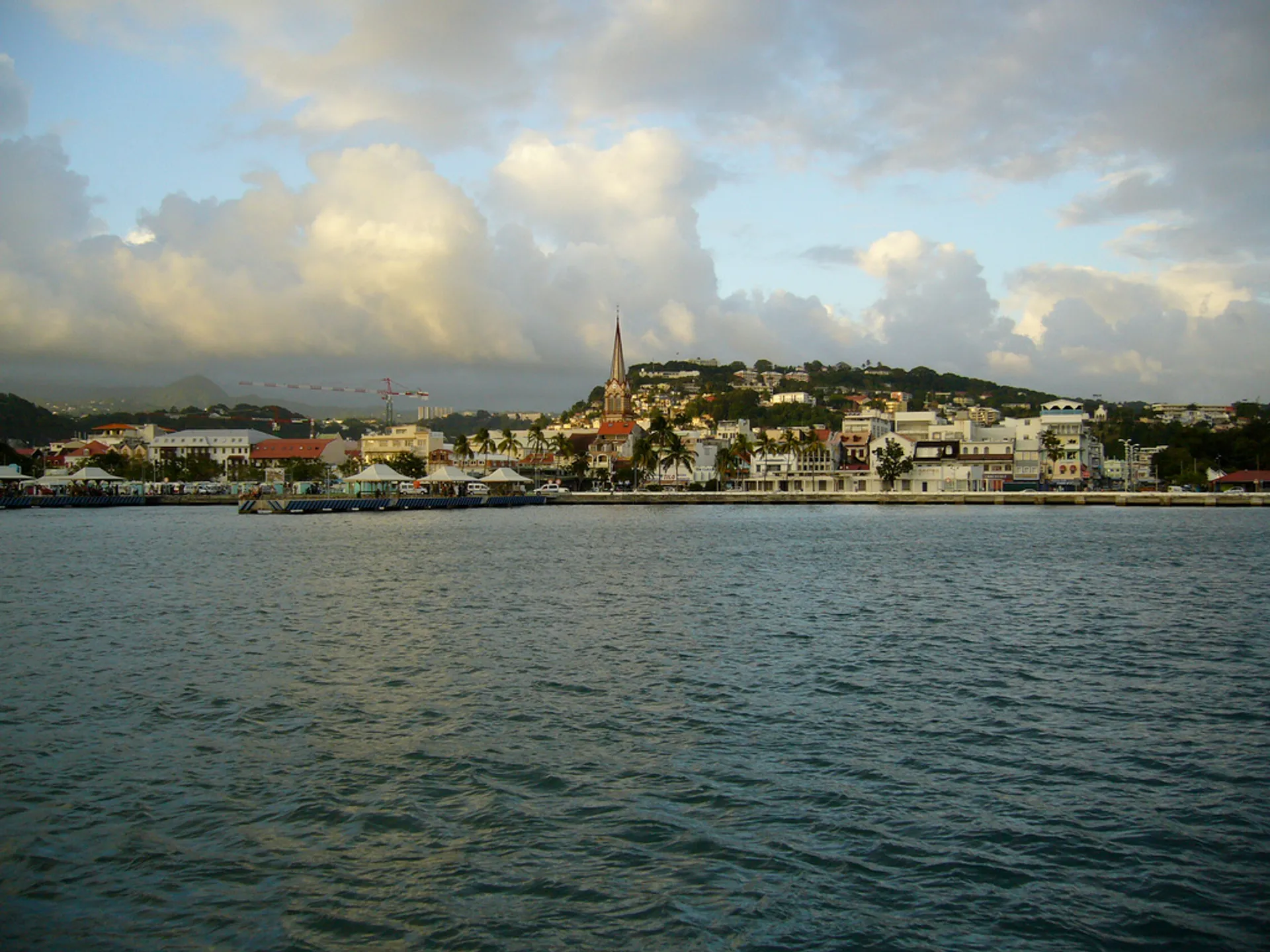 The image shows a coastal scene with a body of water in the foreground, which