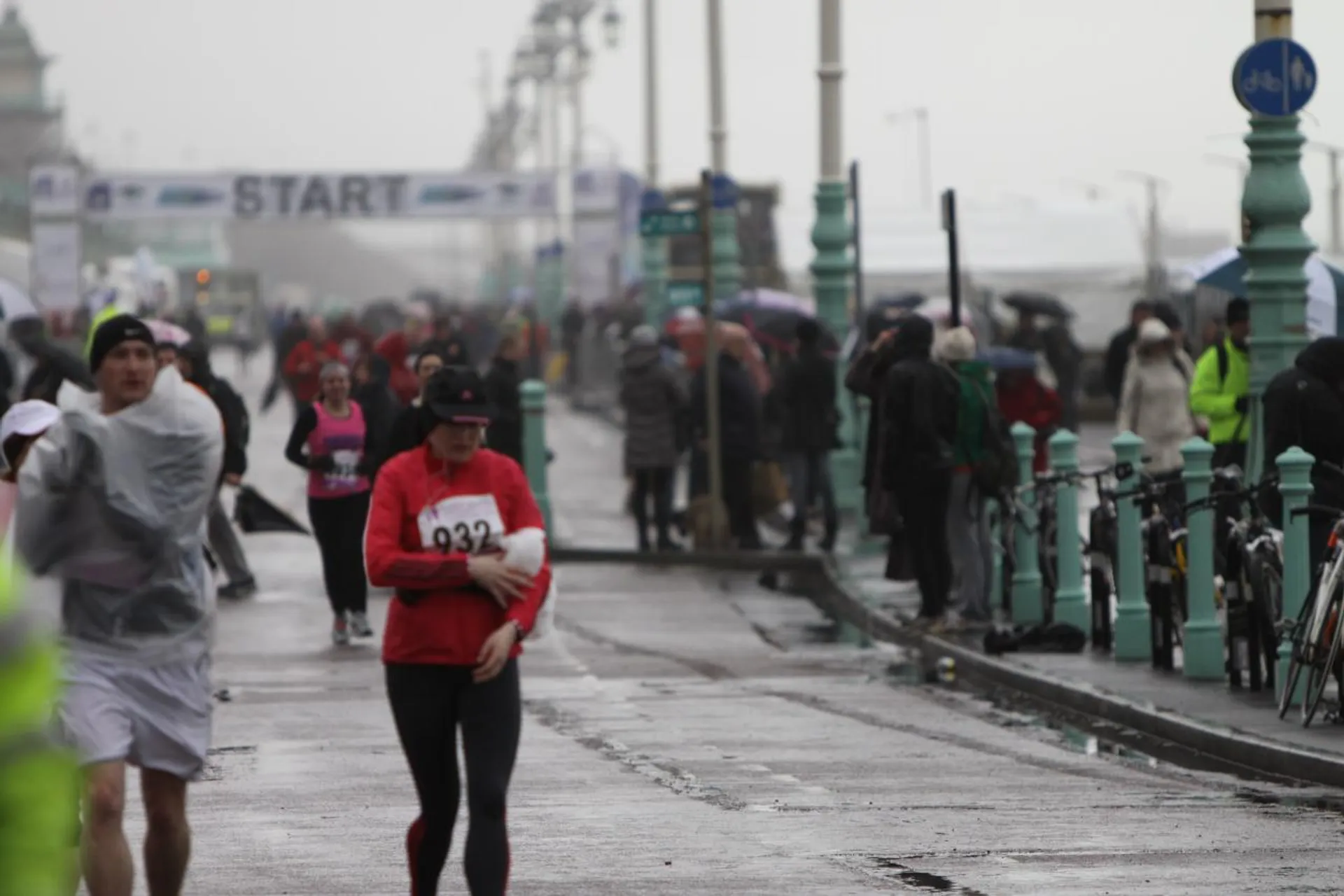 This image appears to capture a scene from a running event under what looks like rainy