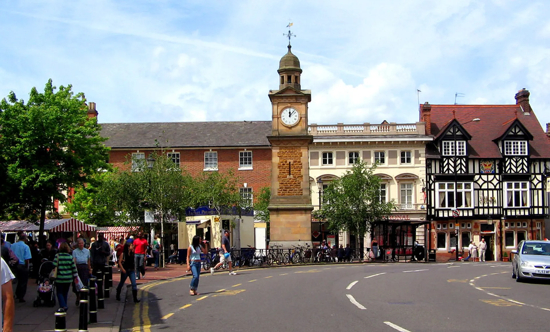 The image shows a streetscape with a variety of architectural styles. On the left