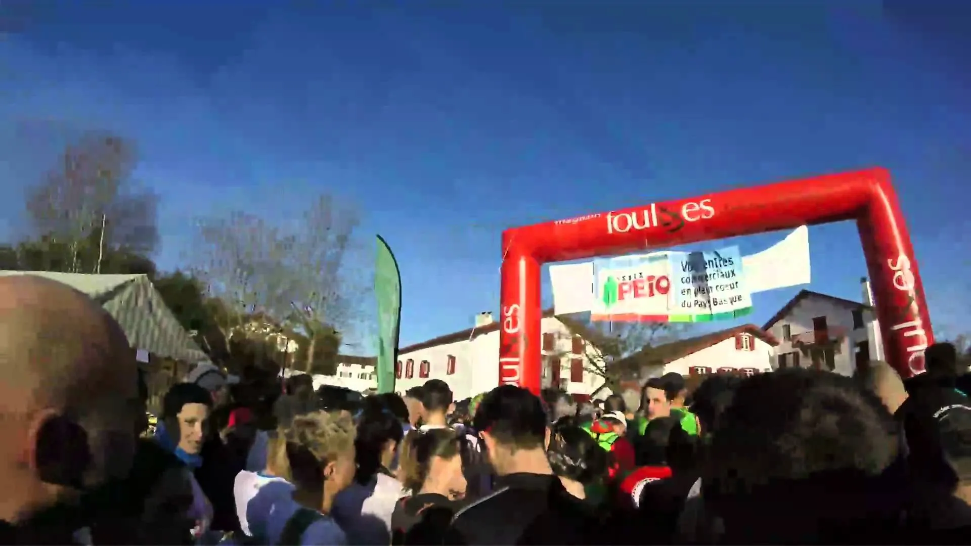 The image shows a crowd of people gathered at what appears to be the start of