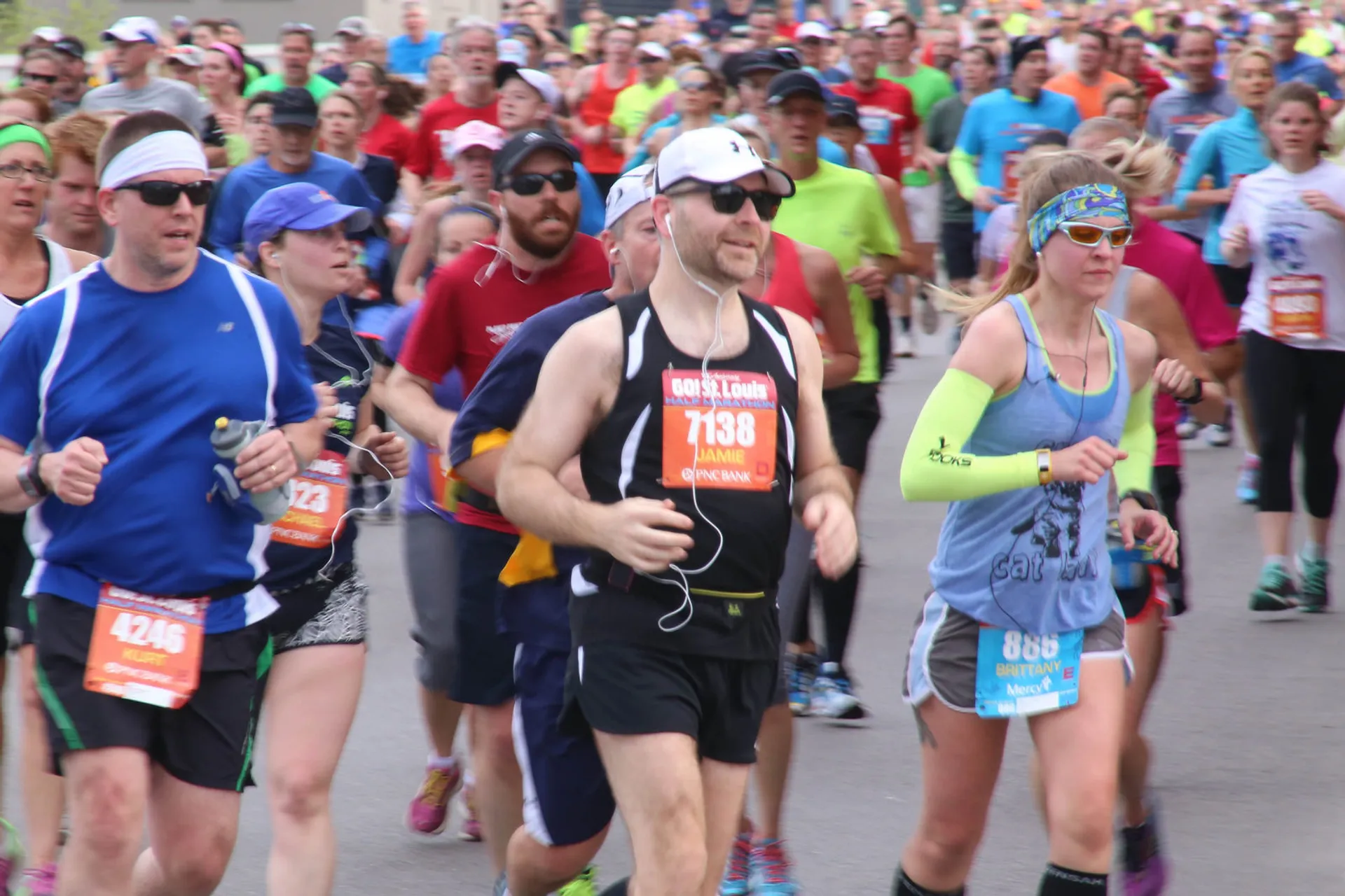 The image shows a group of people participating in a running event such as a marathon