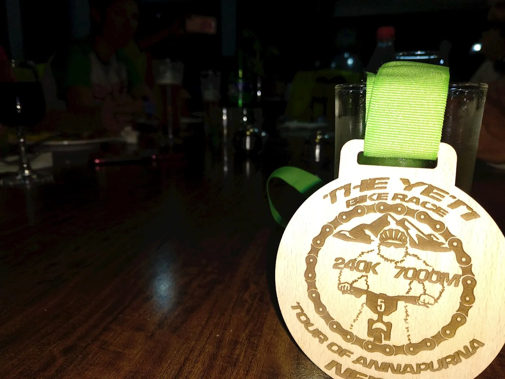 In this image, we see a wooden circular medal placed on a table, featuring