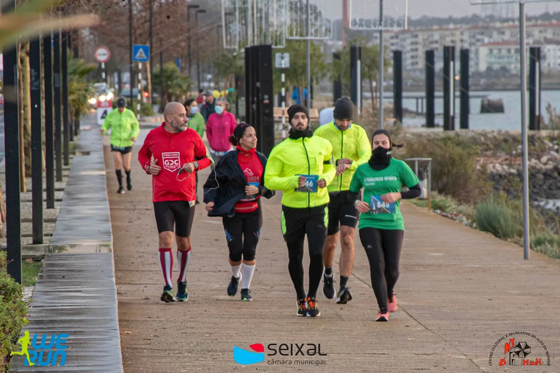 This image shows a group of people participating in a running event. They are wearing