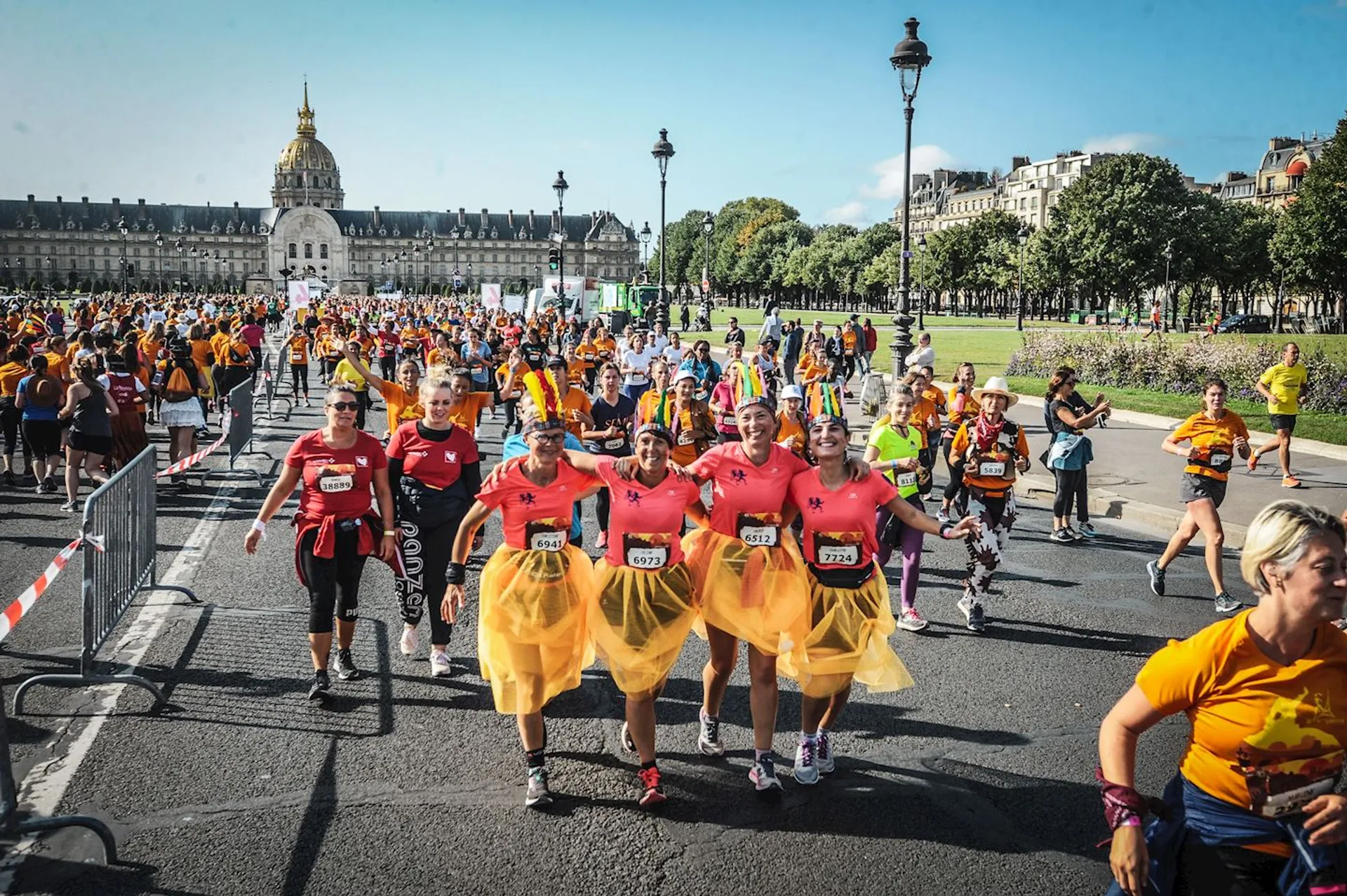 In the image, you can see a group of people participating in a running event