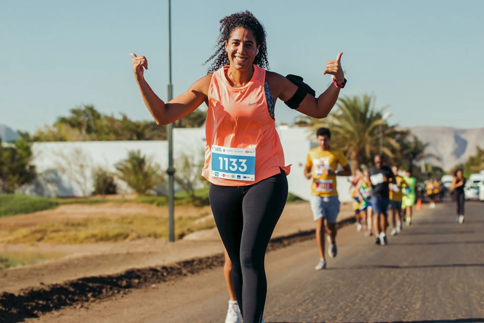 The image shows a group of people participating in a running event, possibly a marathon