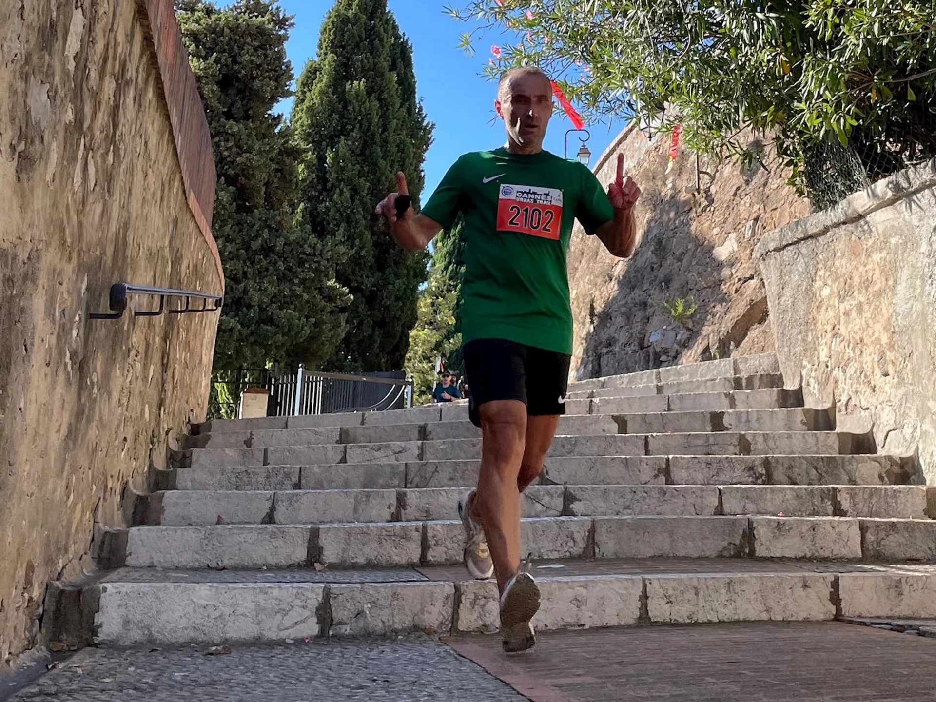 The image shows a person in athletic wear participating in a running event. The individual