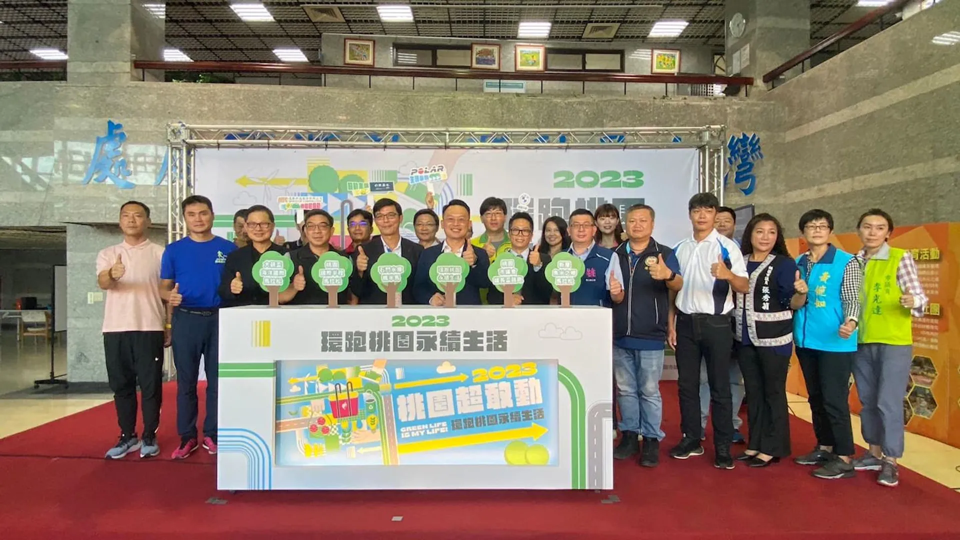 The image shows a group of people posing together for a photograph in front of a