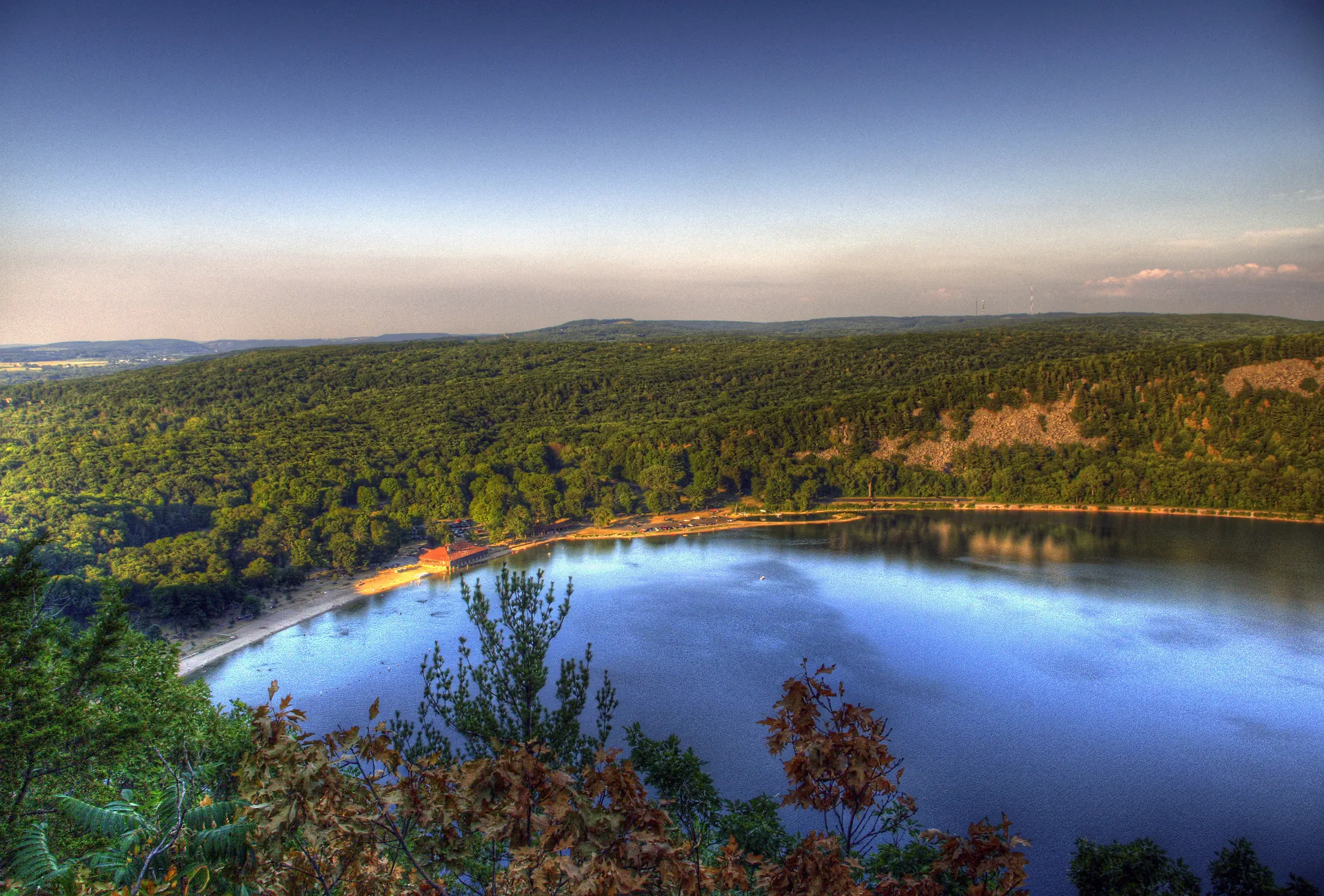 The image shows a captivating landscape view. It features a serene lake surrounded by lush