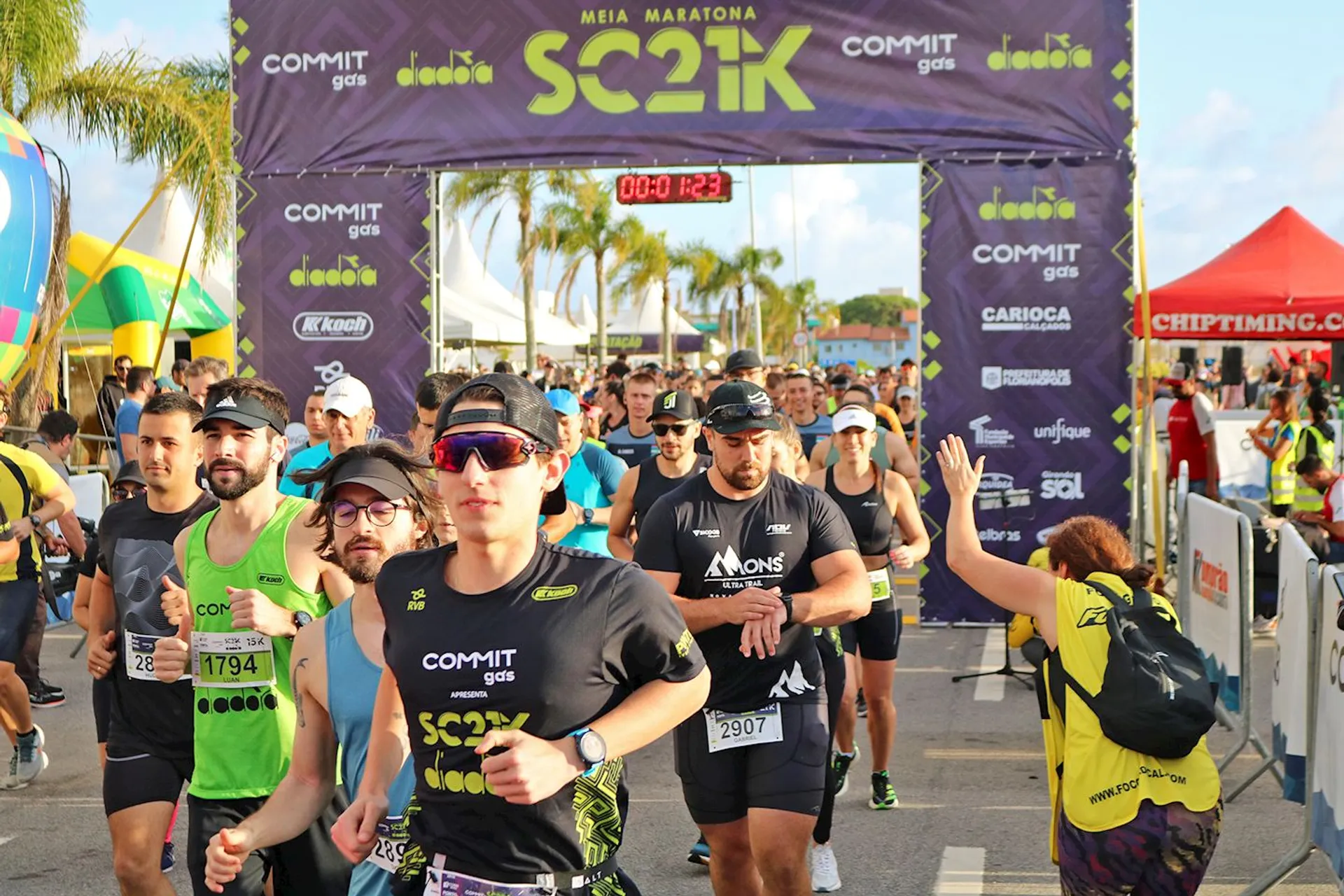 The image depicts a group of runners at the start of a half marathon race.