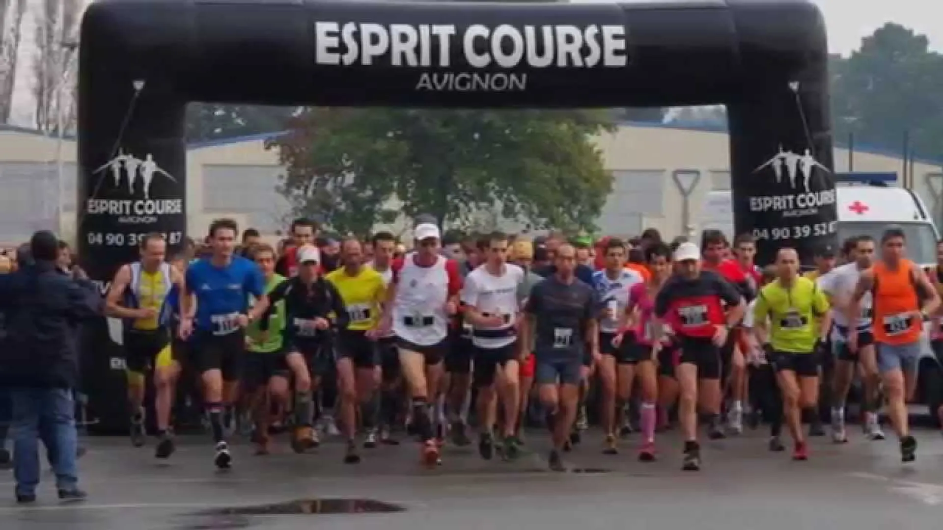 The image shows a group of people participating in a running event. They are just