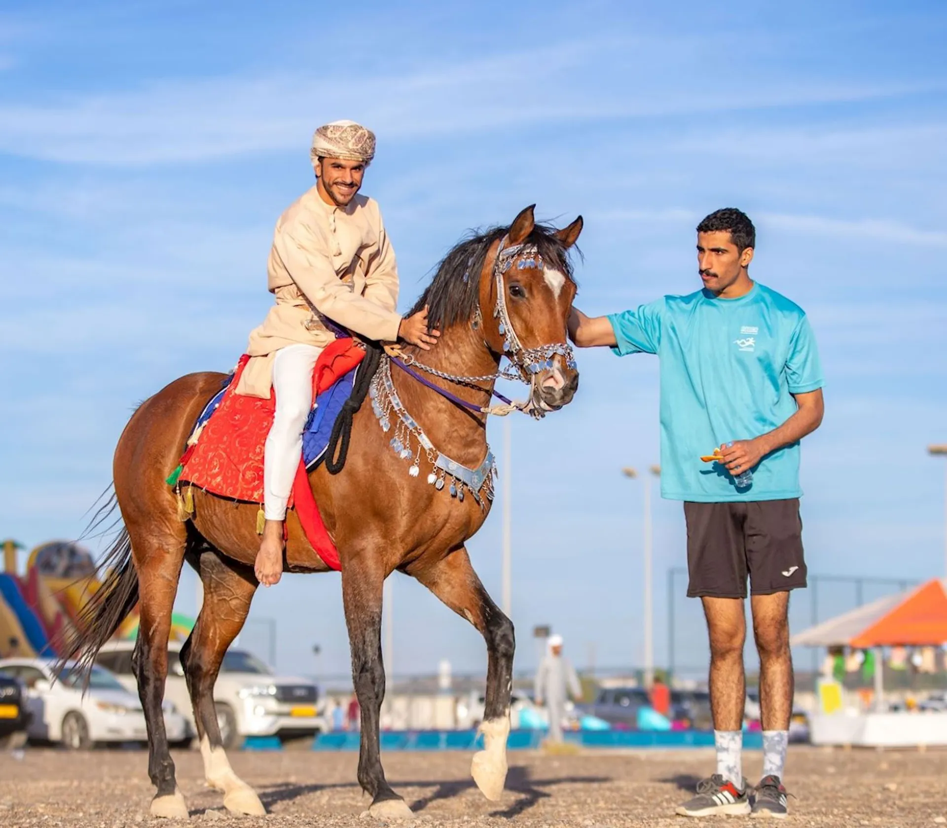 The image shows two individuals and a horse in what appears to be an outdoor setting