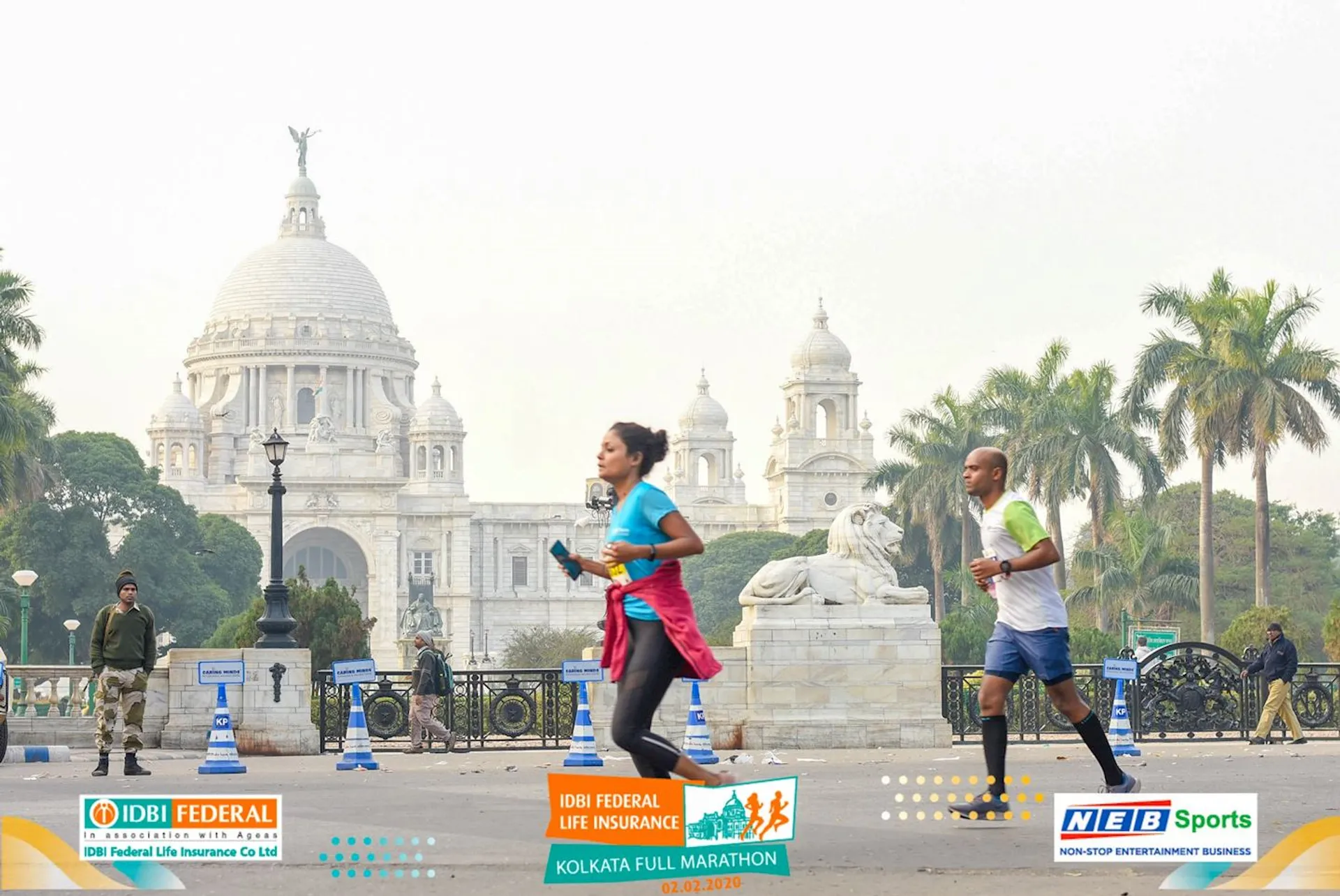 The image features two individuals engaged in running, likely participating in a marathon event,