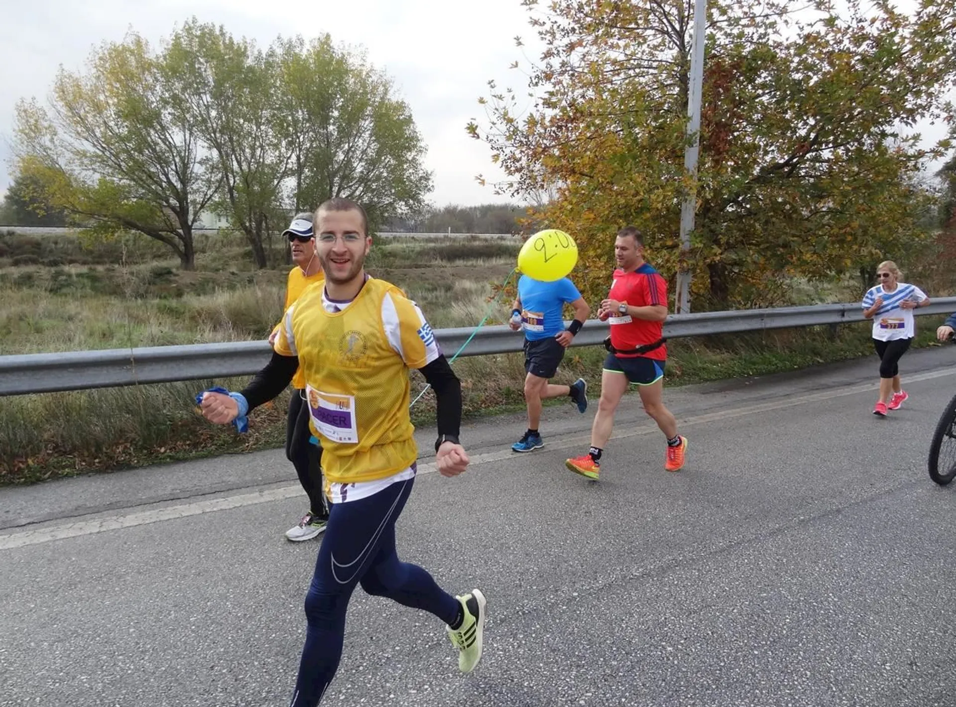 The image shows a group of people participating in a running event. In the forefront