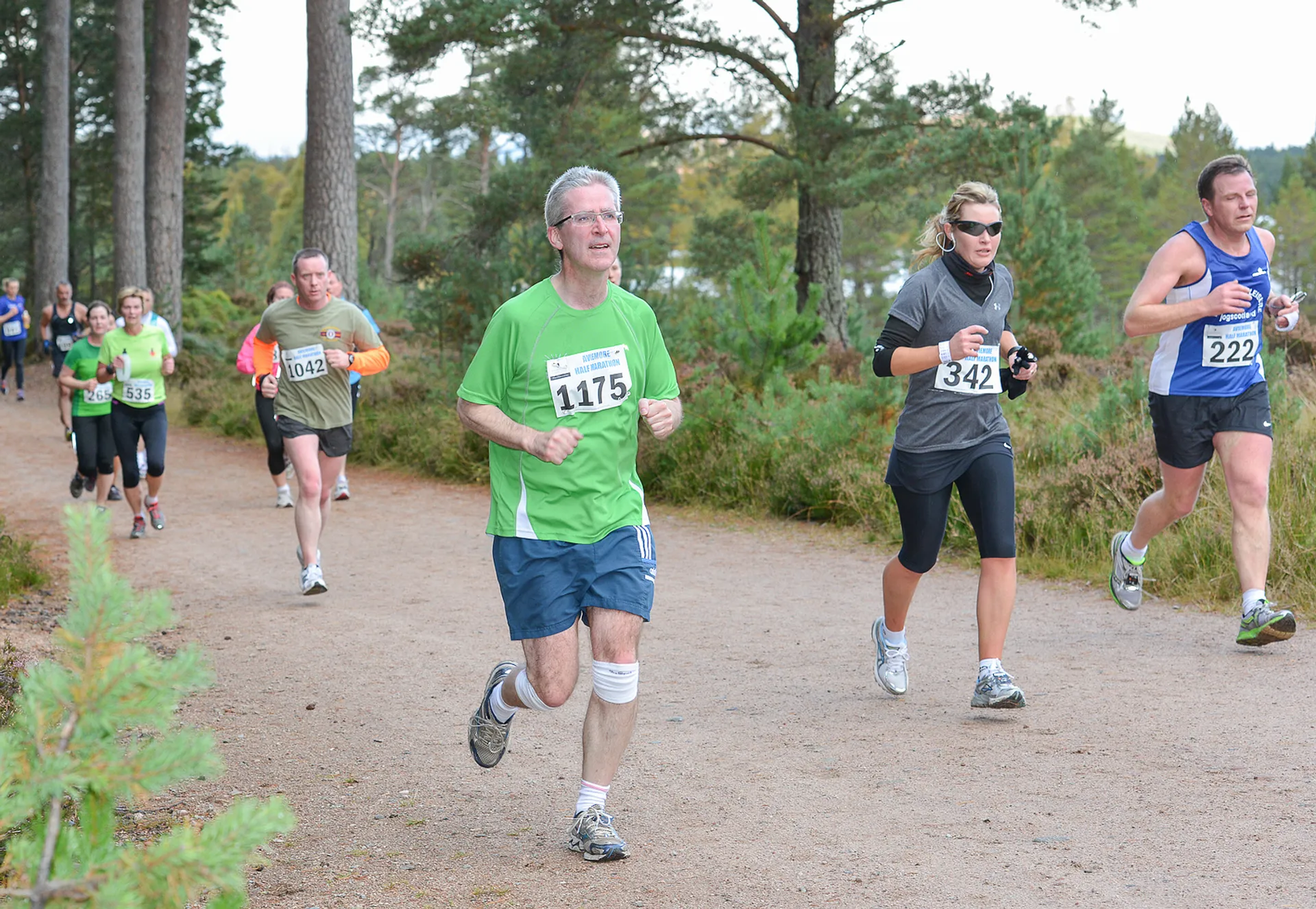 The image shows a group of runners participating in a race or running event, probably