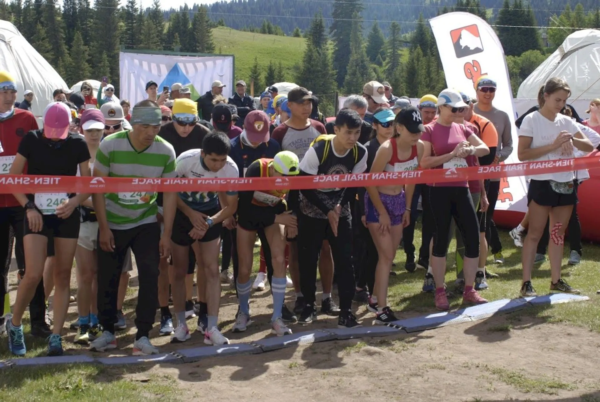 This image shows a group of individuals at the starting line of what appears to be
