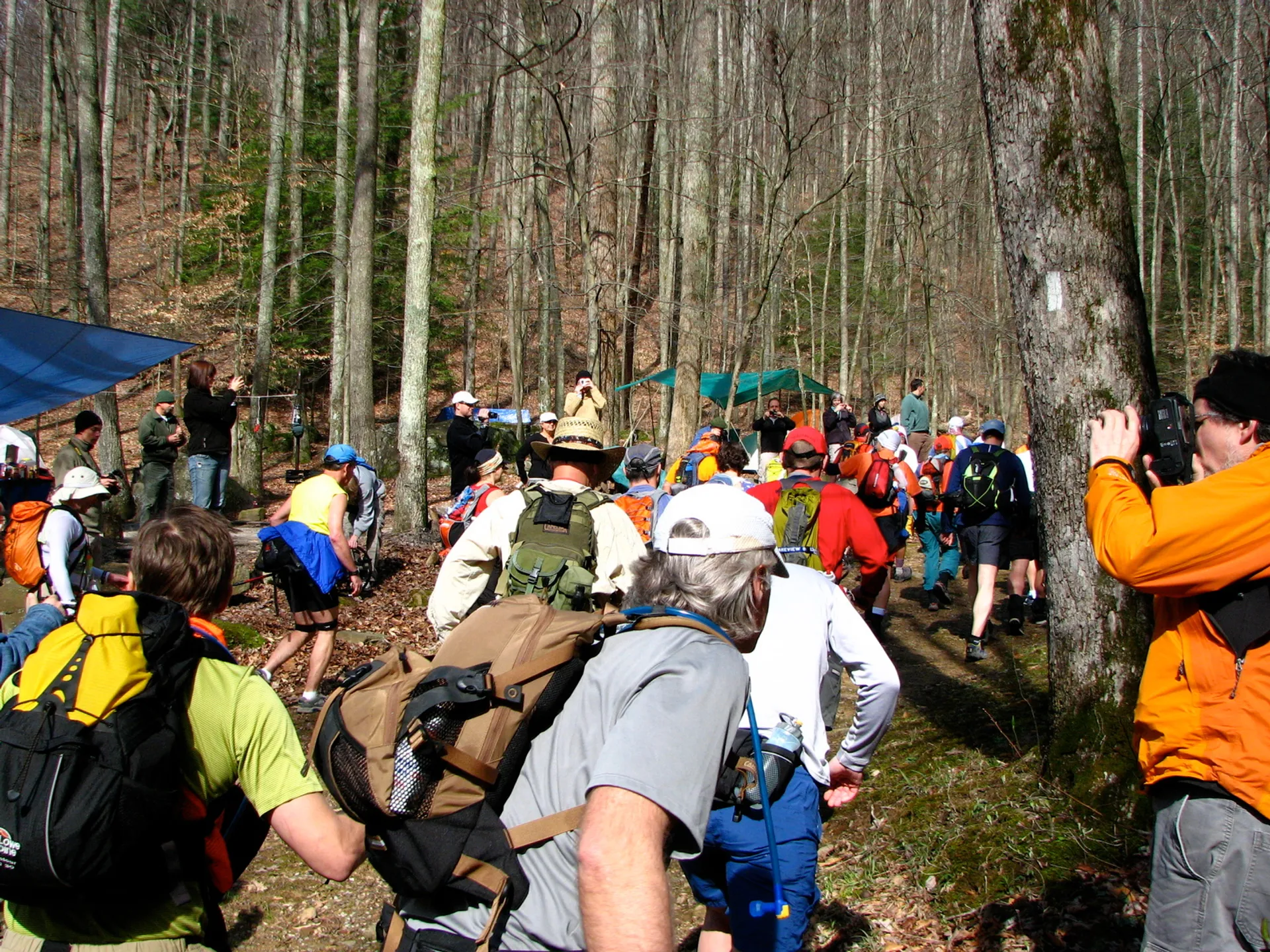 The image shows a group of people, likely hikers or participants in an outdoor