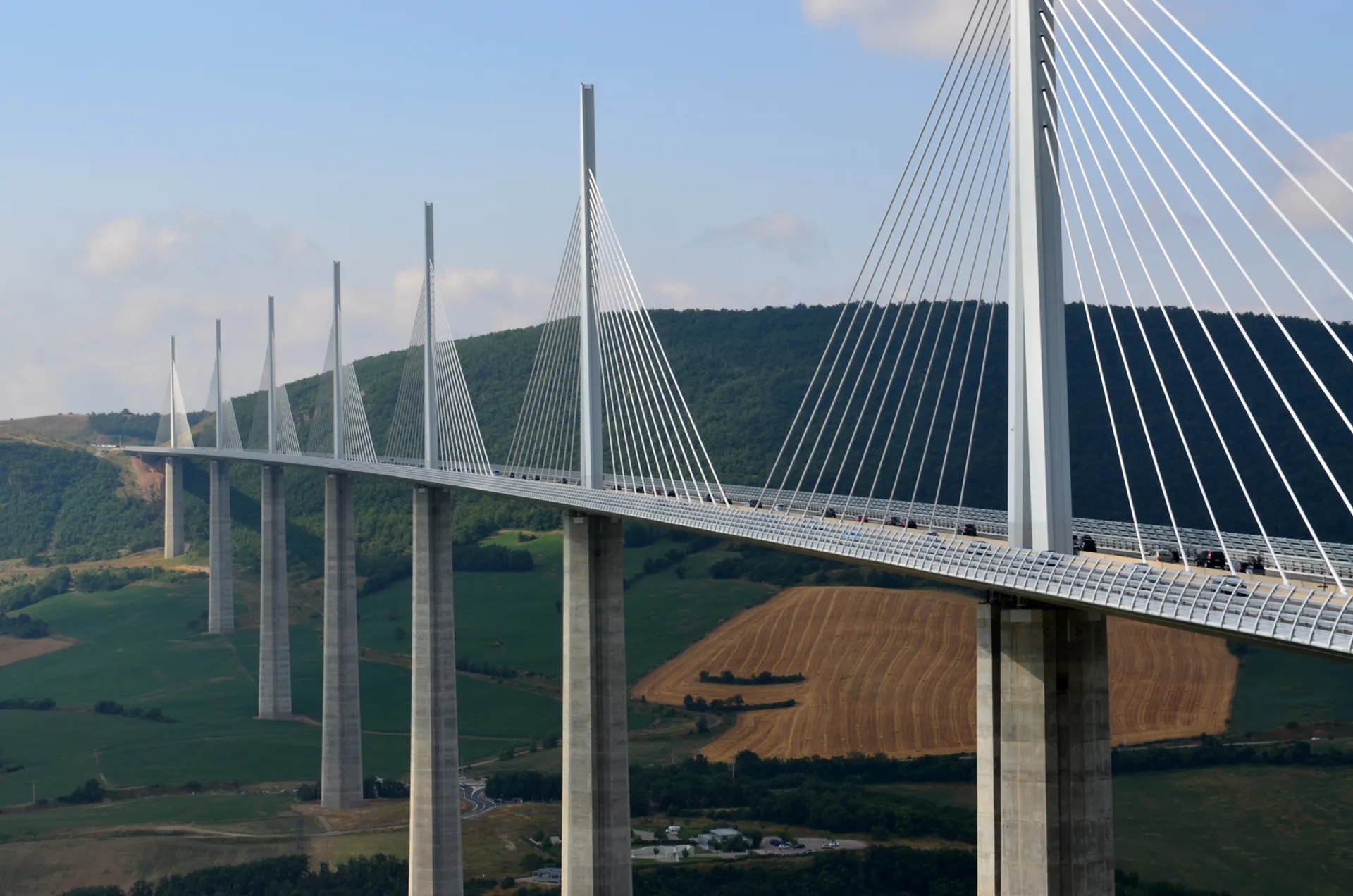 The image showcases a large cable-stayed bridge, characterized by its towers and sweeping