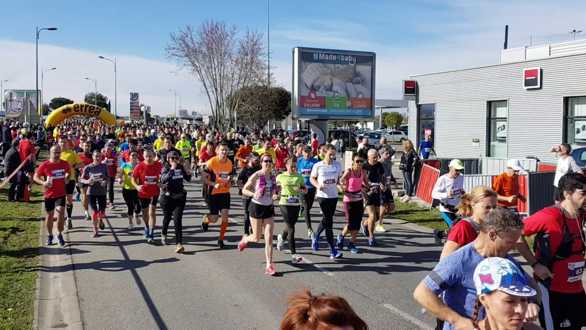 The image shows a group of people participating in a running event. It appears to