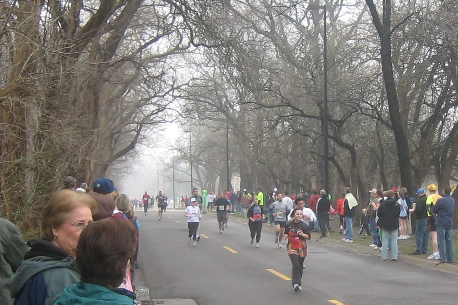 The image shows a group of people participating in a running event. It appears to