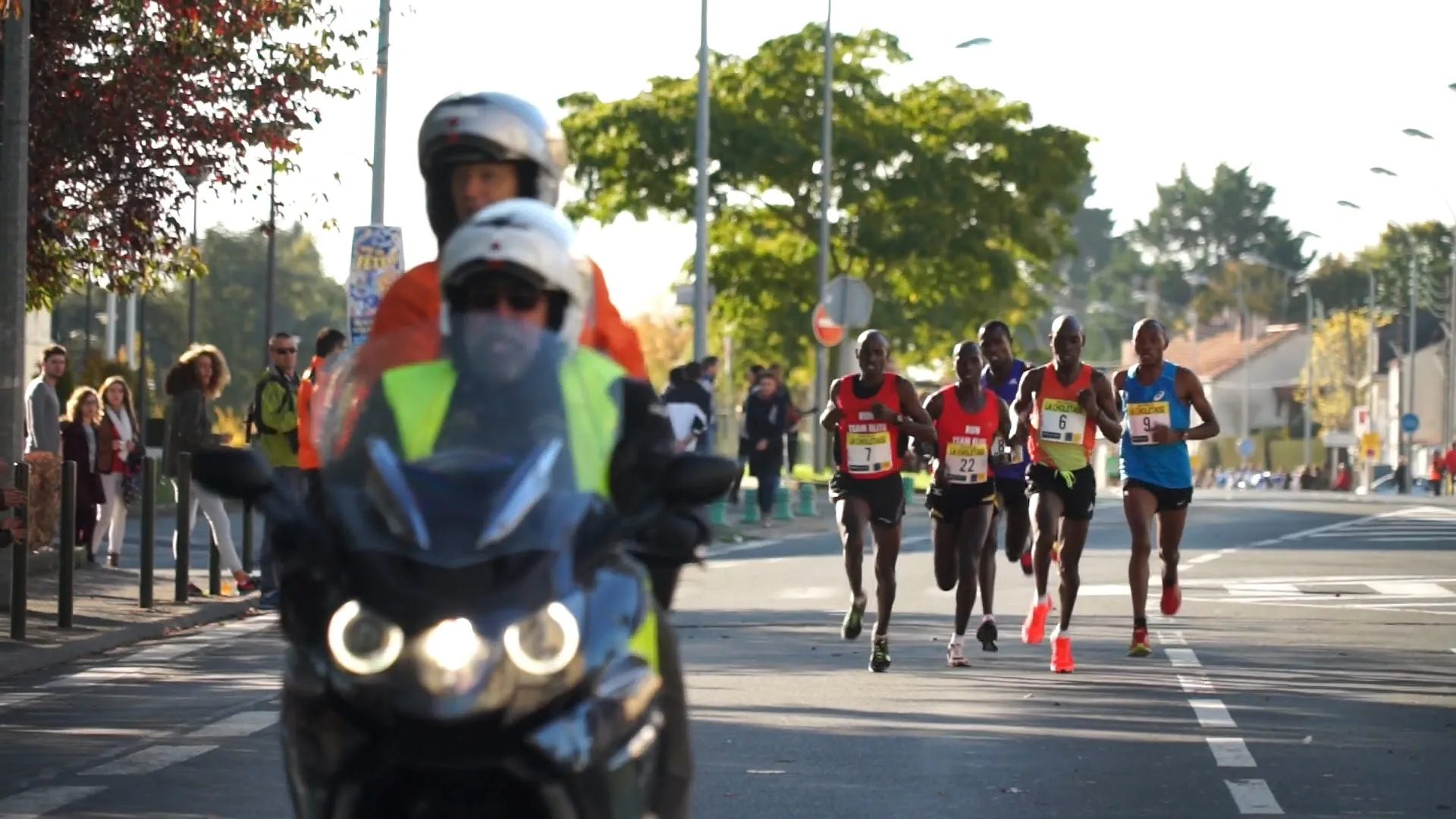 This image depicts a road race scenario. In the foreground, there's a motor