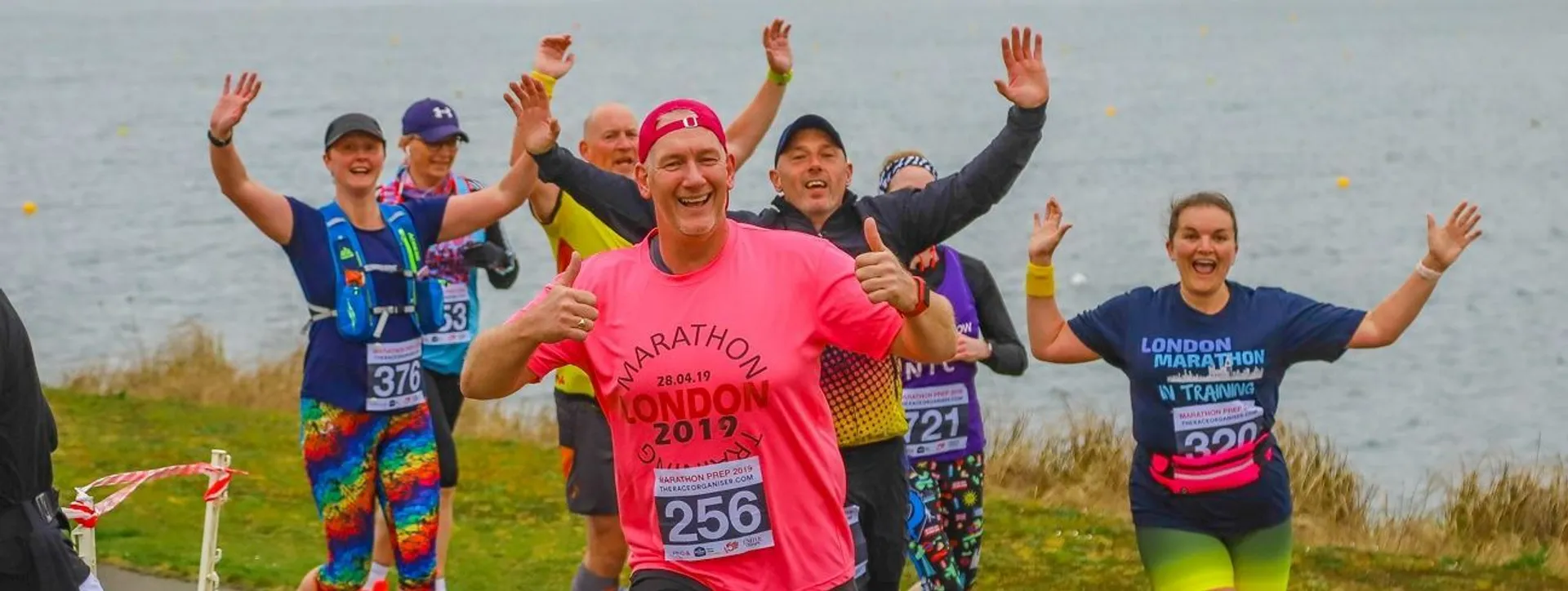 In the image, there is a group of happy runners, likely participating in a