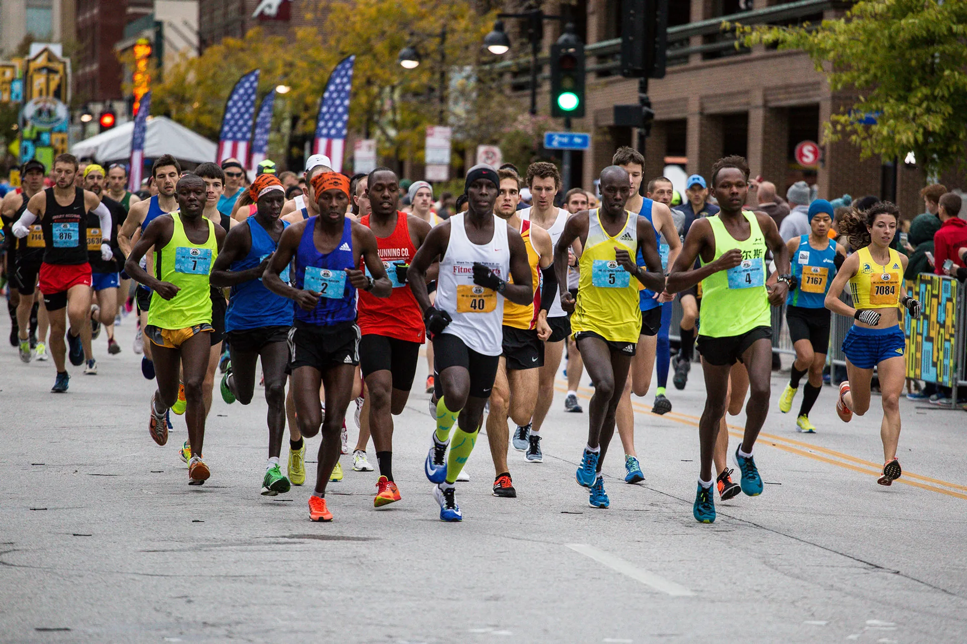 This image shows a group of runners participating in a road race, likely a marathon