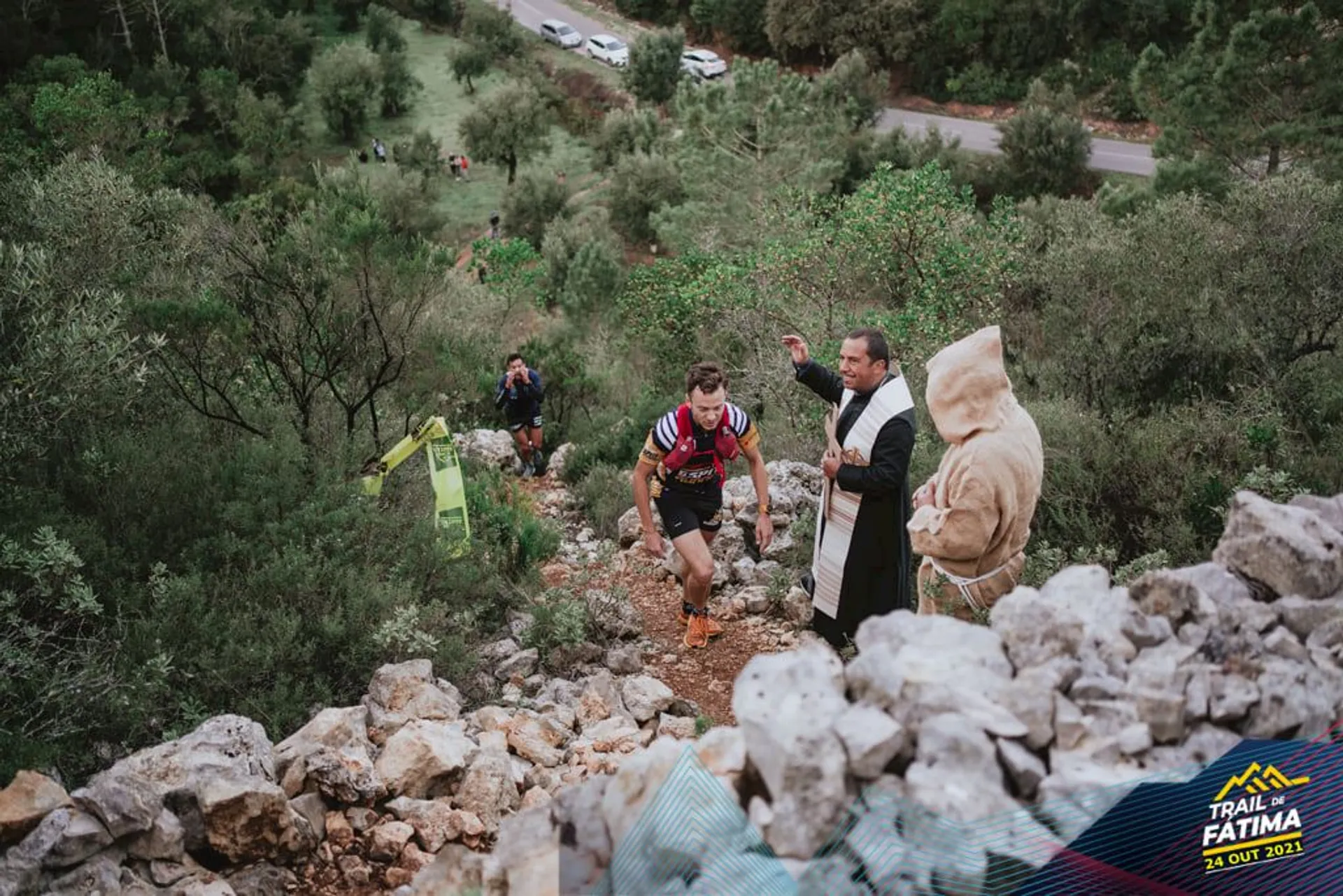 The image shows an outdoor scene where a trail running event is taking place. There