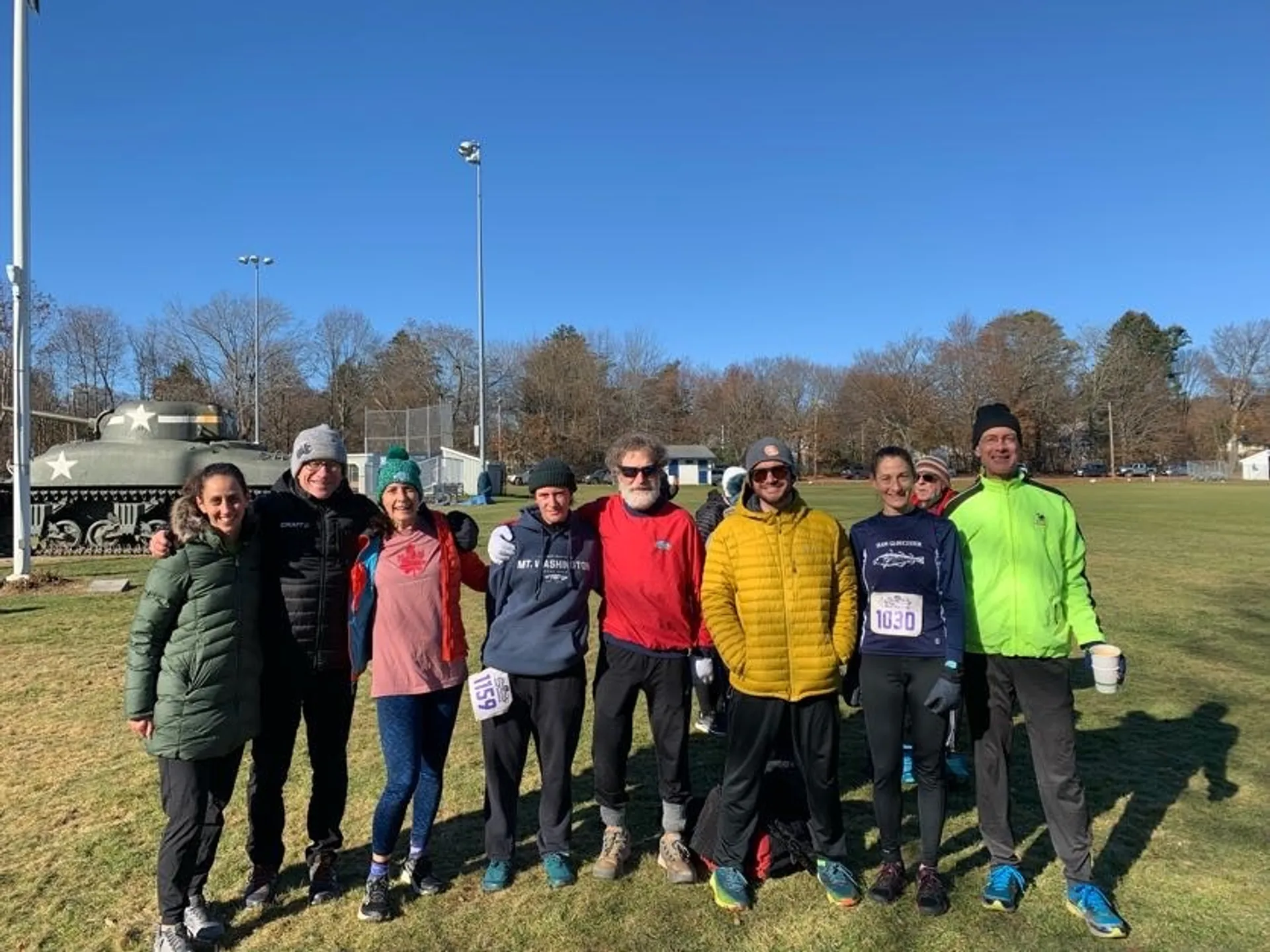 The image shows a group of people who appear to be runners, as some are